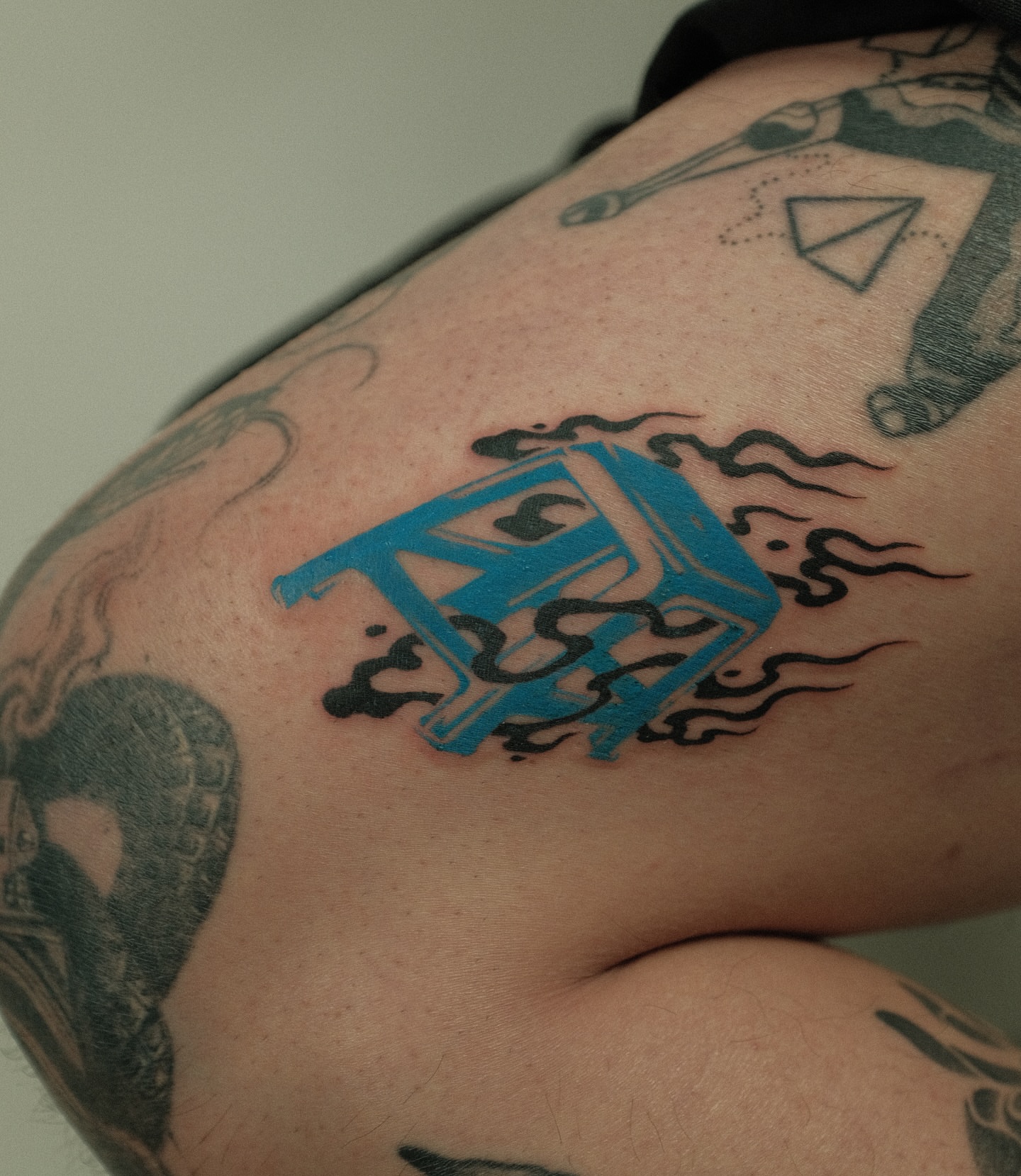 Blue letter 'A' new school tattoo on the thigh by Xiao Lun
