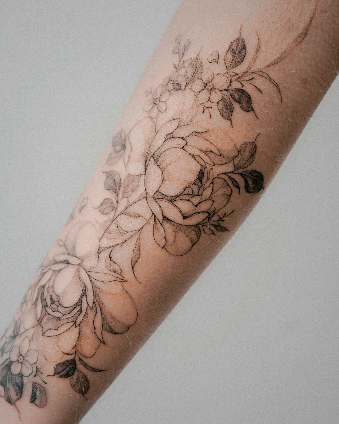Floral bouquet black and grey tattoo on the forearm by Yeonji