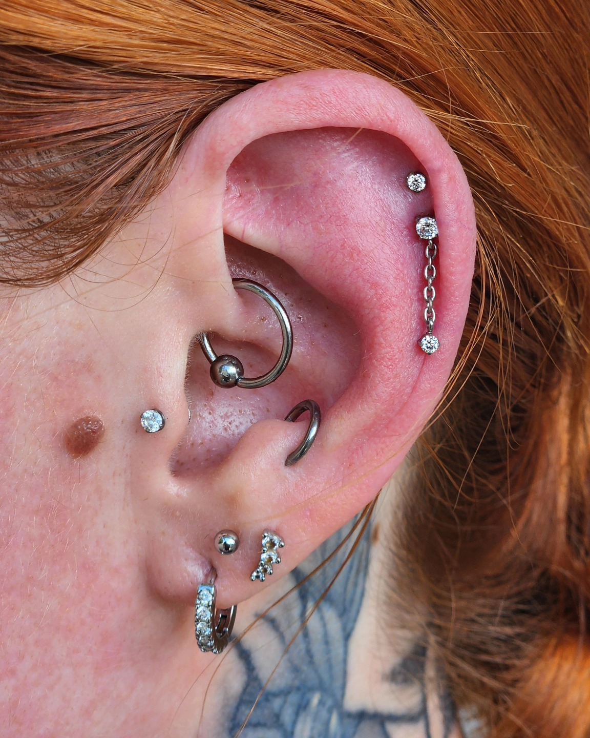 Ear piercings geometric tattoo by Madison Fleishman, Southampton, Pennsylvania