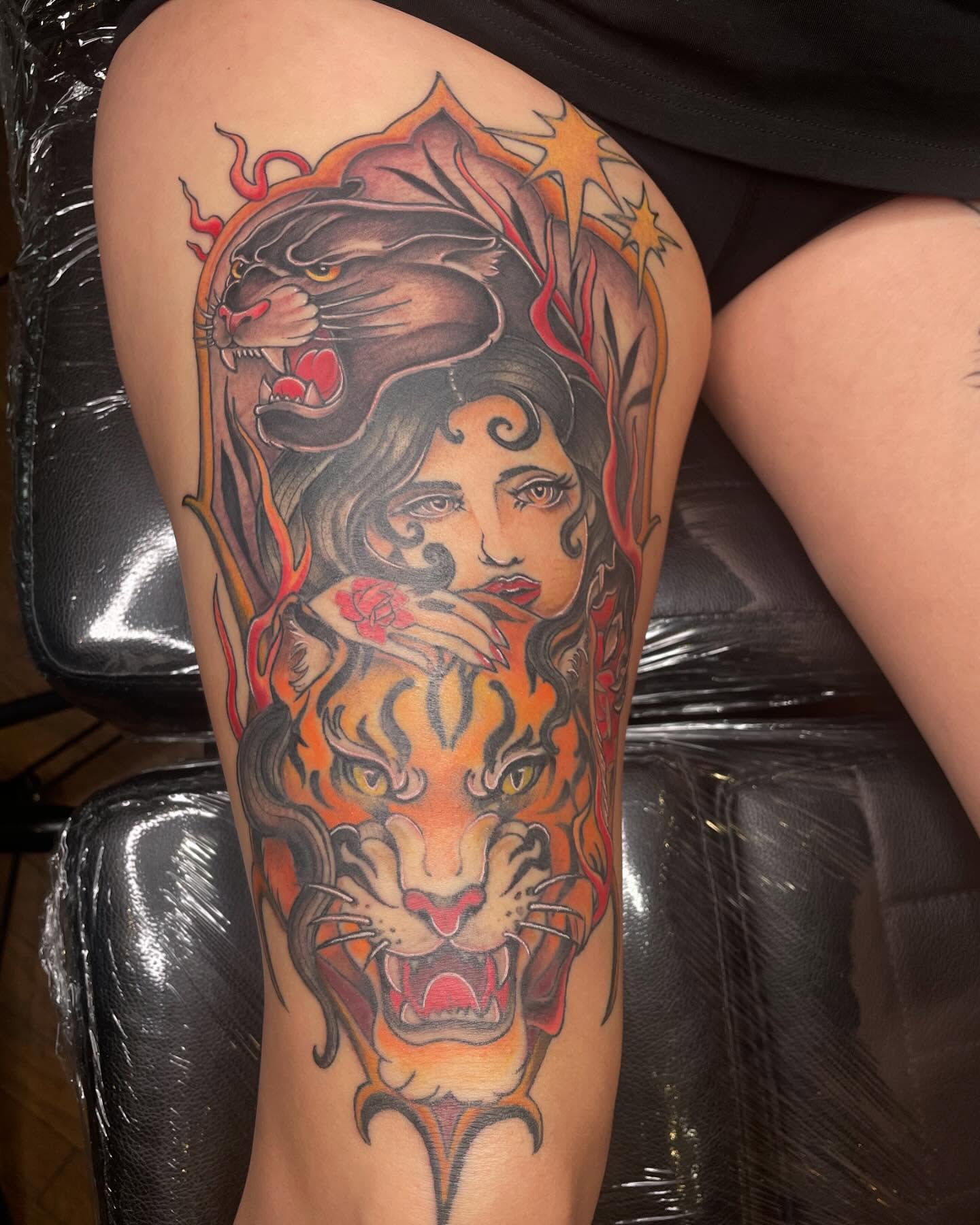 Woman with tiger American traditional tattoo on the thigh by Lauren Sisouphanh, Canton, Ohio