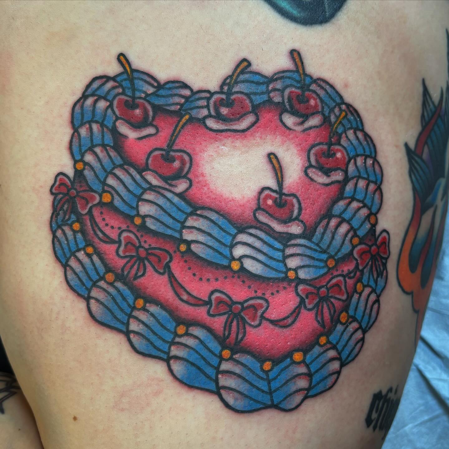 Heart-shaped cake American traditional tattoo on the thigh by Brandi ⛓, Detroit, Michigan