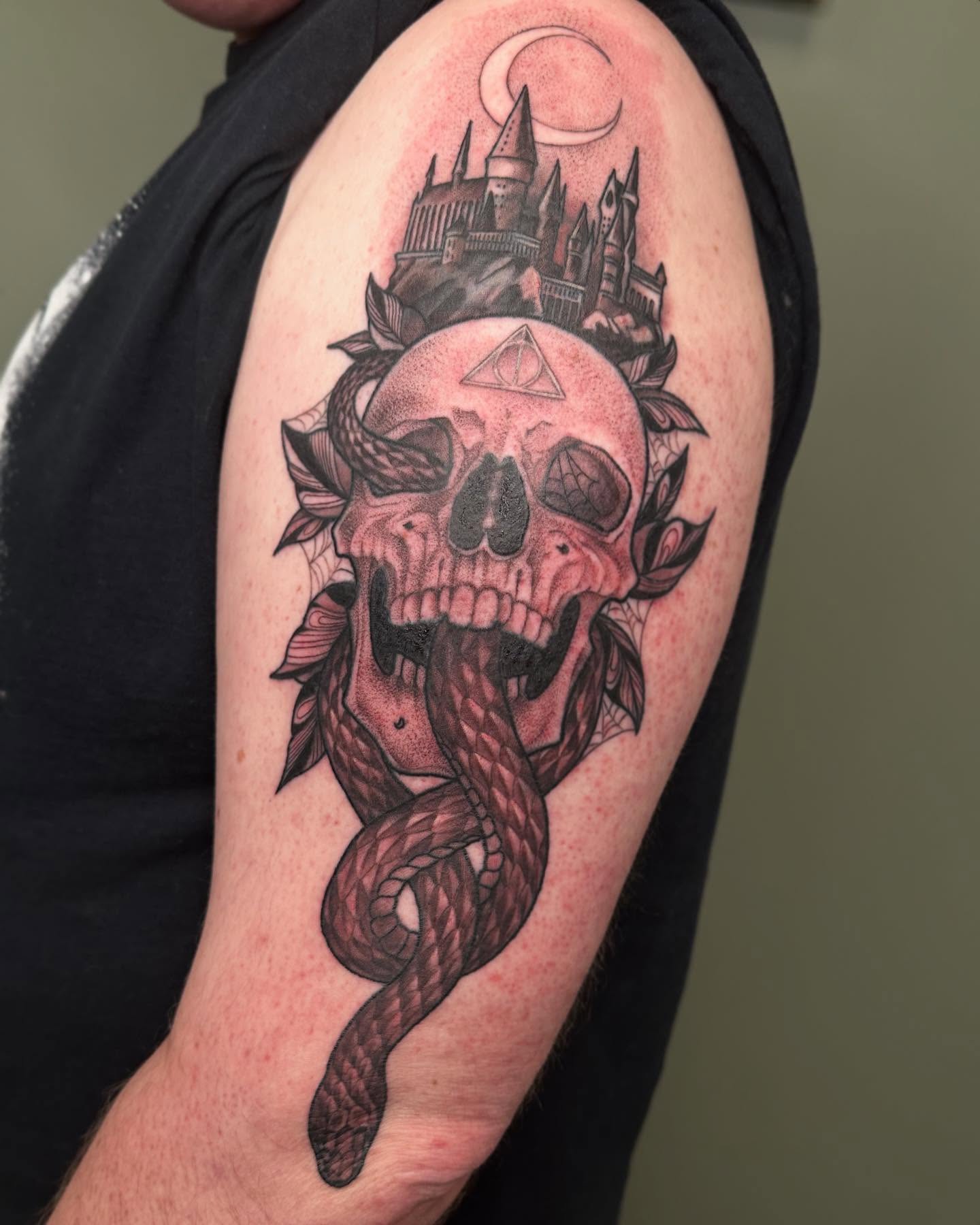 Skull with snake dark realism tattoo on the shoulder by Hi