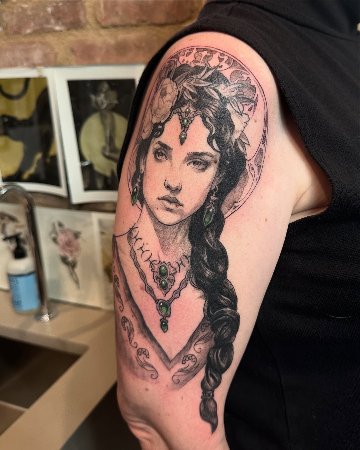 Woman with braided hair realism tattoo on the upper arm by Ben Cisek