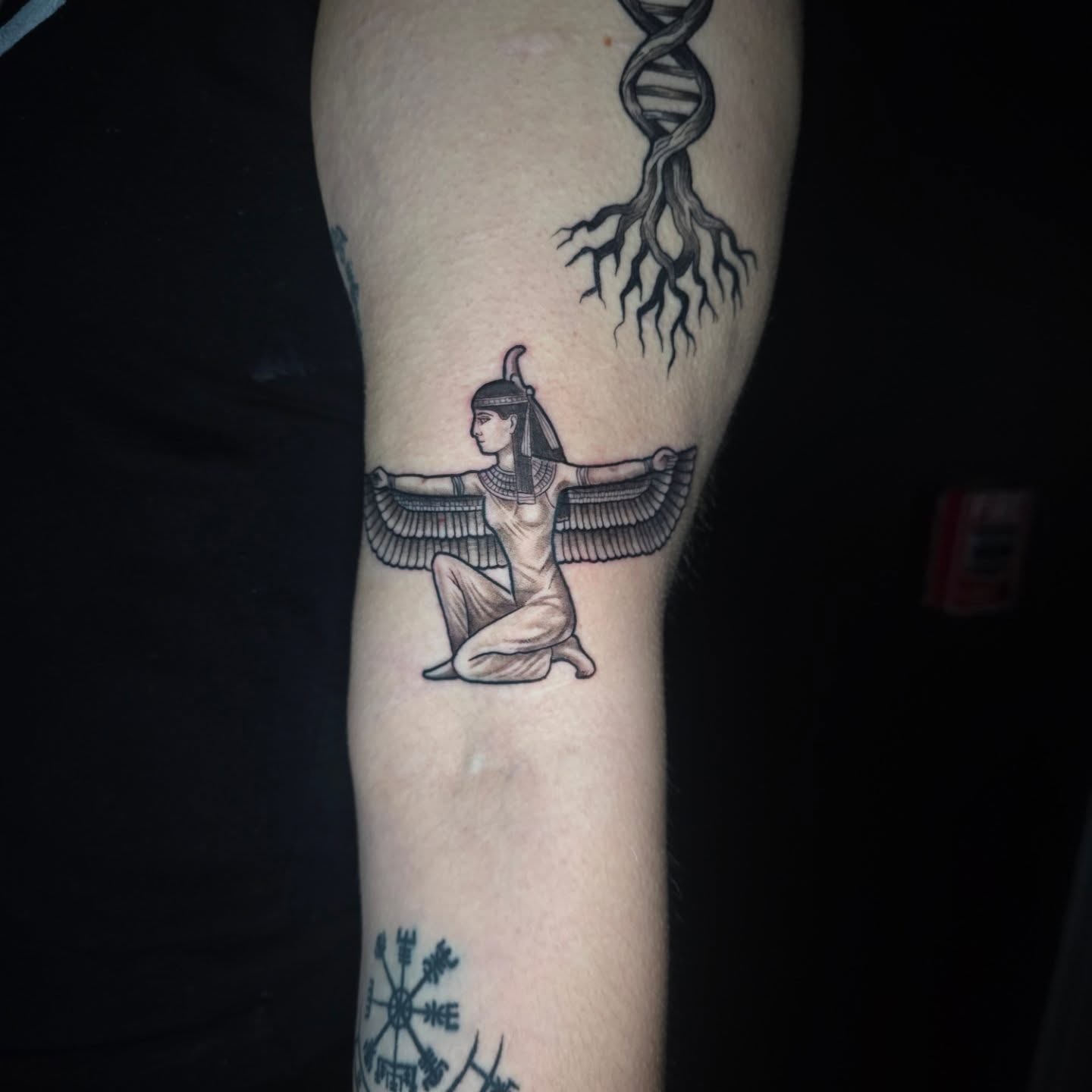 Egyptian deity with wings black and grey tattoo on the forearm by Anna Brittany