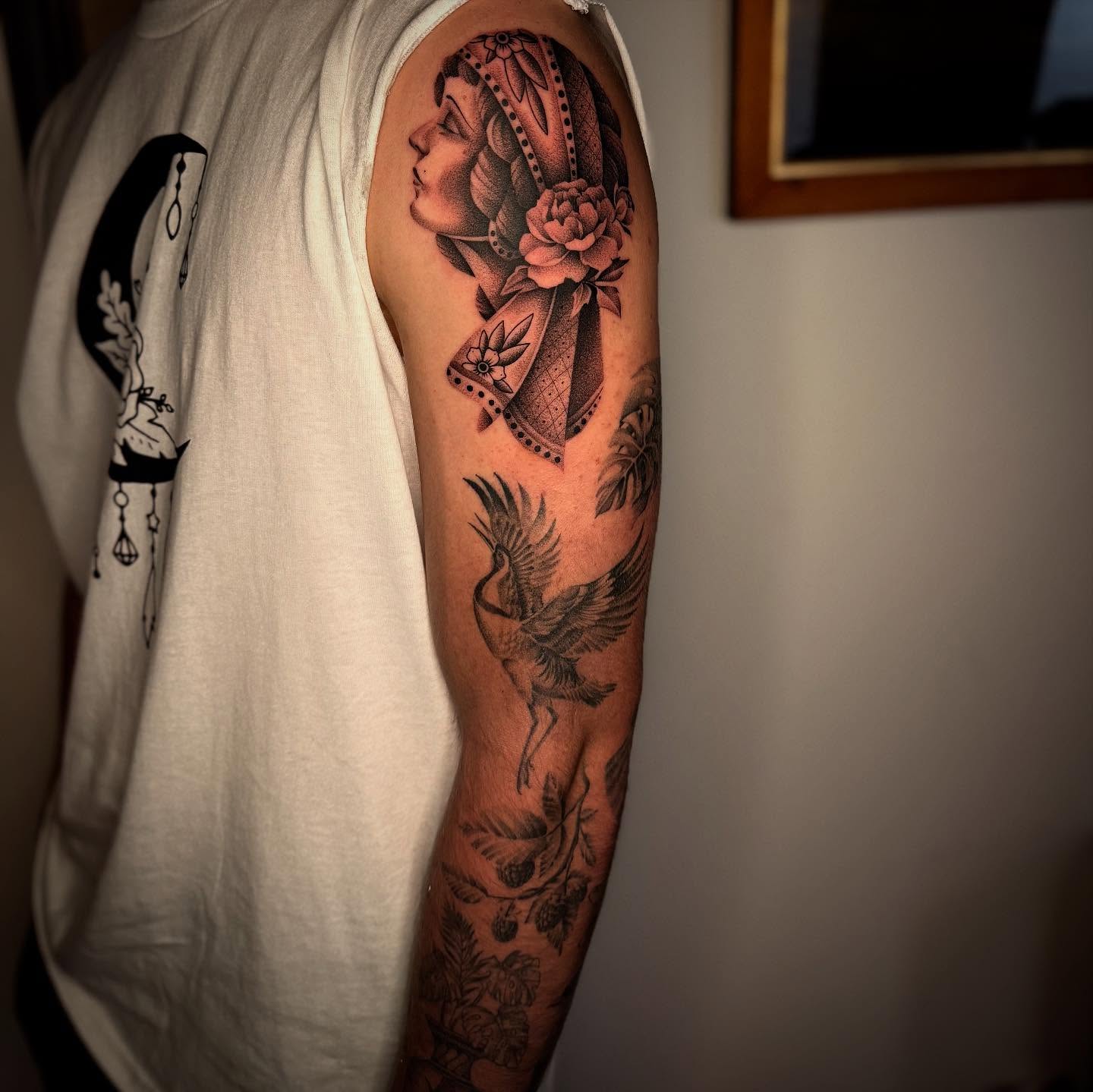 Woman with bird American traditional tattoo on the upper arm by Jacob Deirfield, Circleville, Ohio