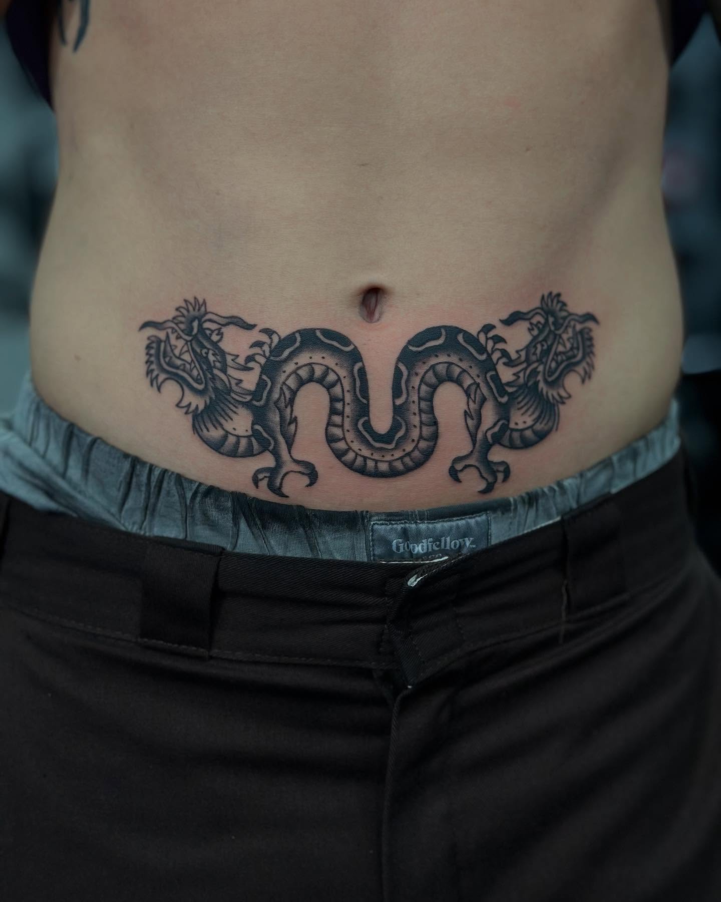 Dragon black and grey tattoo on the torso by Lissy Red