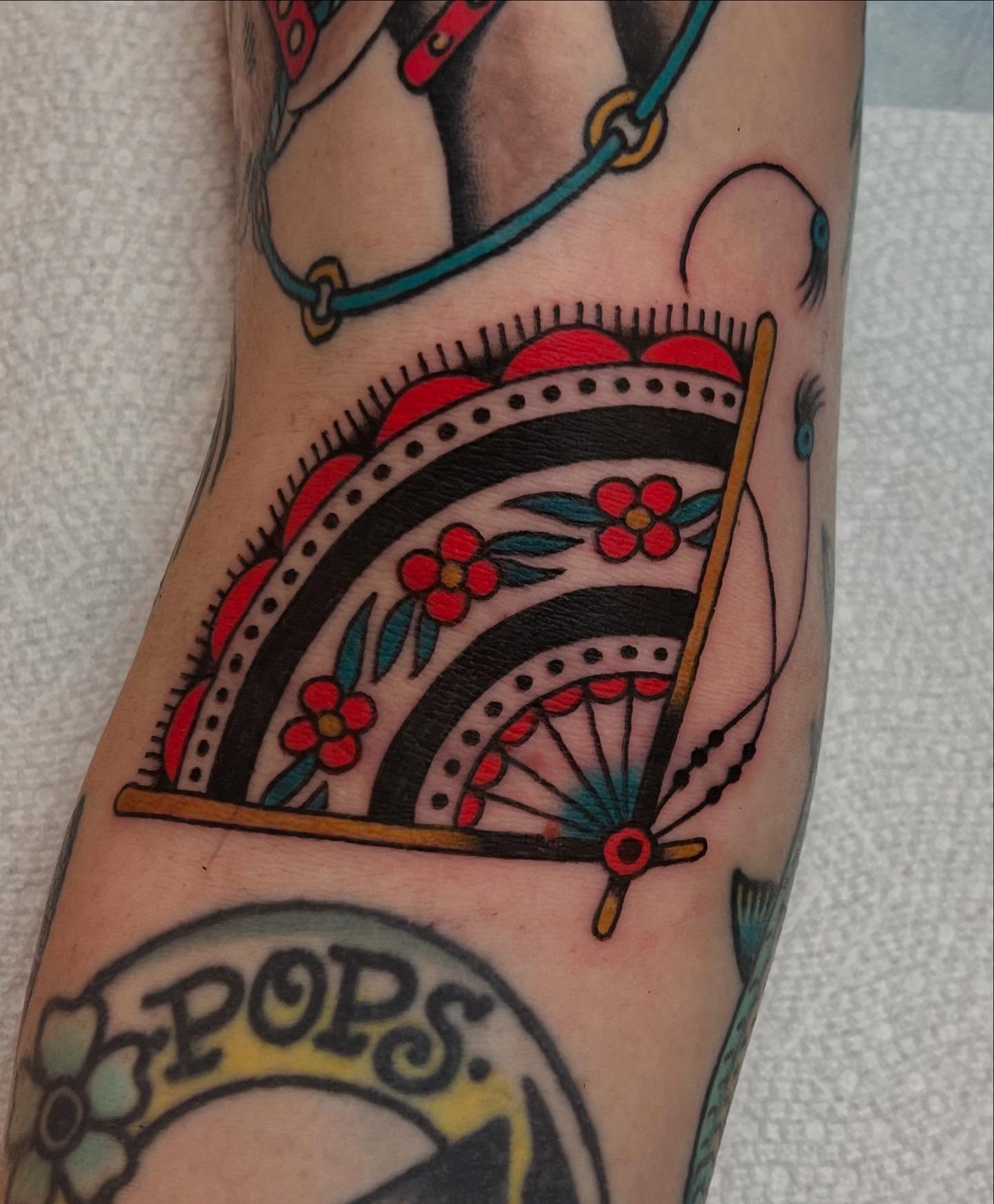 Wheel and floral American traditional tattoo on the forearm by Liv :)