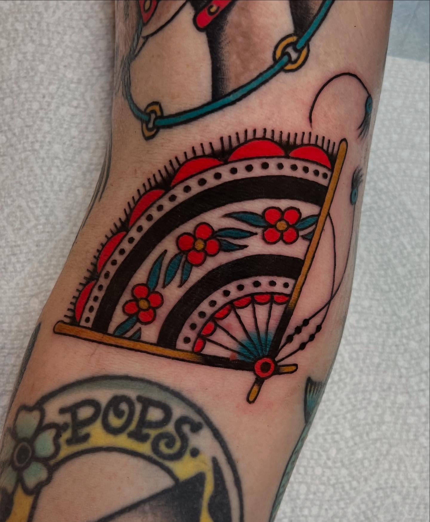 Wheel and floral American traditional tattoo on the forearm by Liv :)