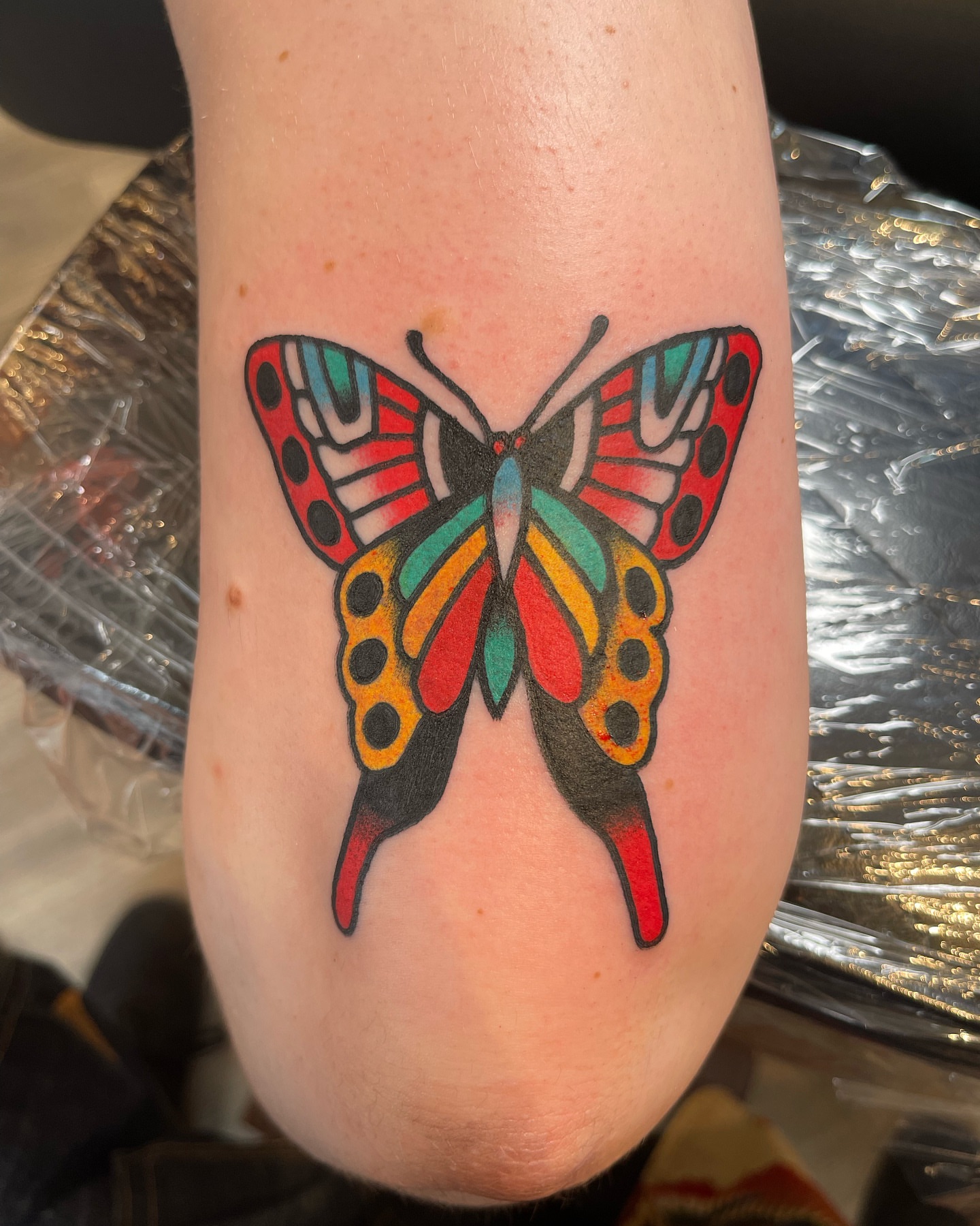Butterfly American traditional tattoo on the forearm by Jeff Miller philly traditional tattoo