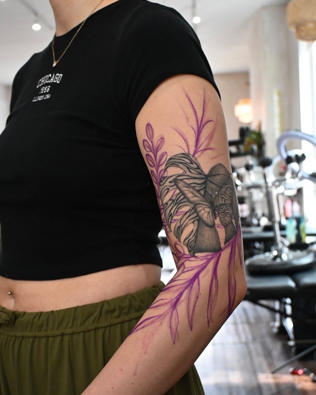 Elephant and purple feather black and grey tattoo on the forearm by Simba Nguyen