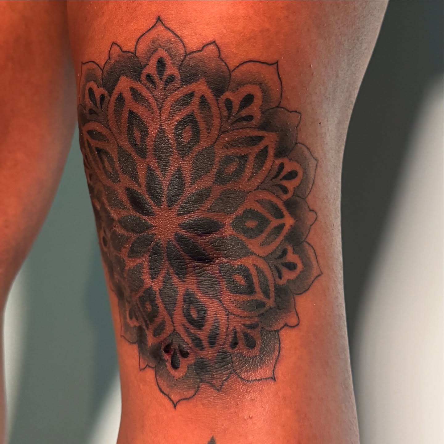 Mandala black and grey tattoo on the forearm by Tori Bent