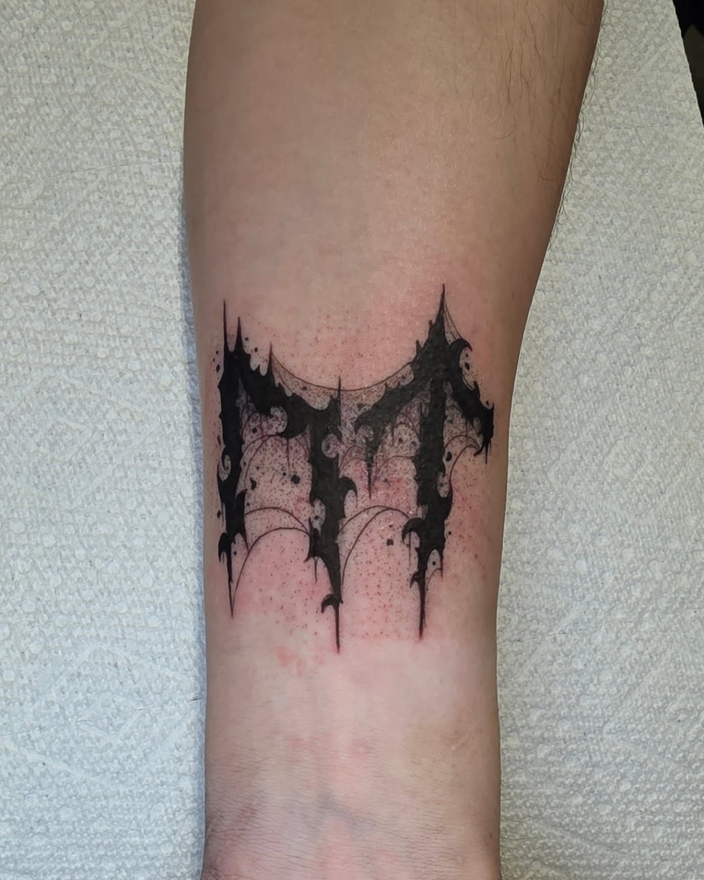 Gothic lettering black and grey tattoo on the forearm by Kelsey Lorrae, Ankeny, Iowa