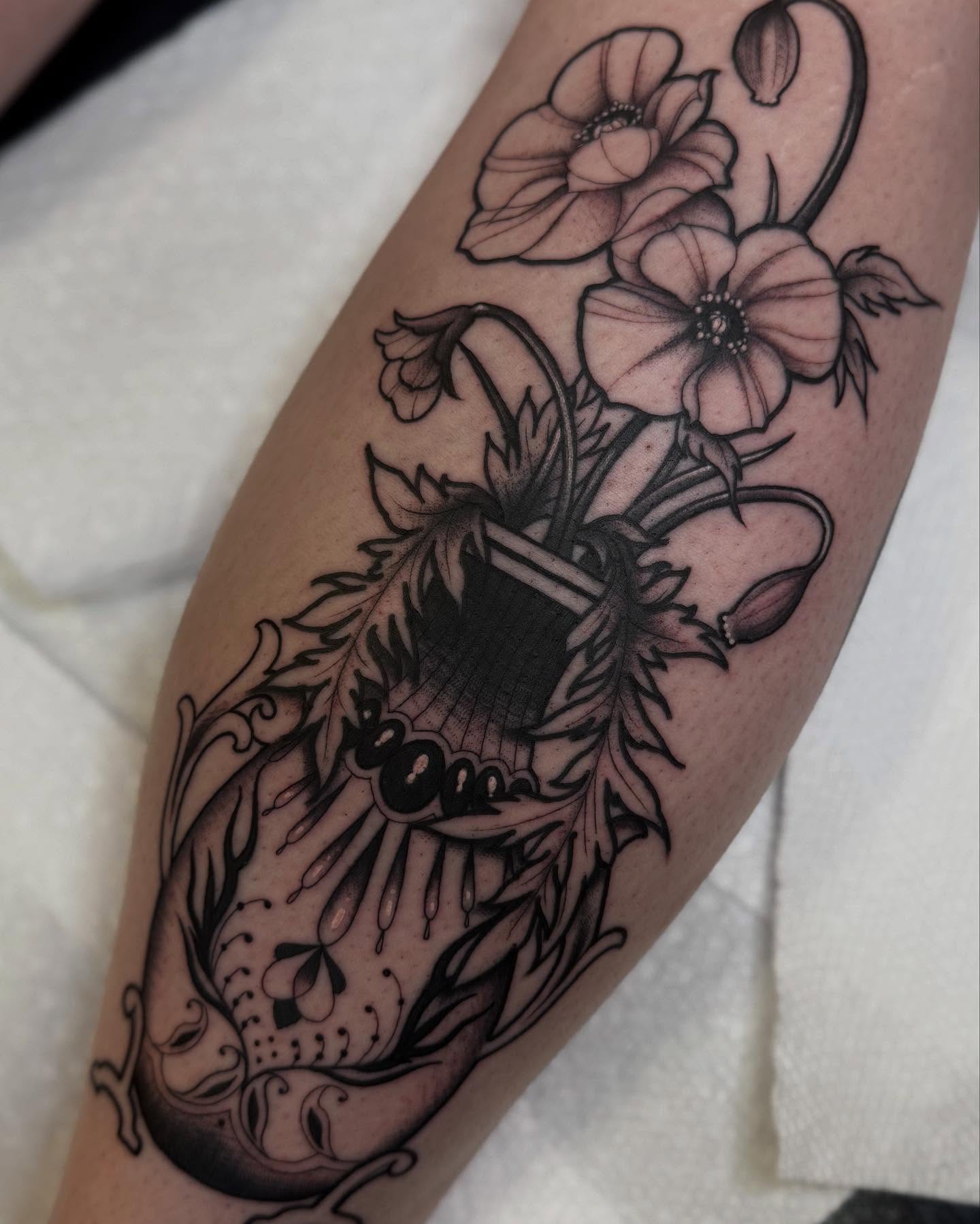 Flower and butterfly black and grey tattoo on the forearm by Espinal