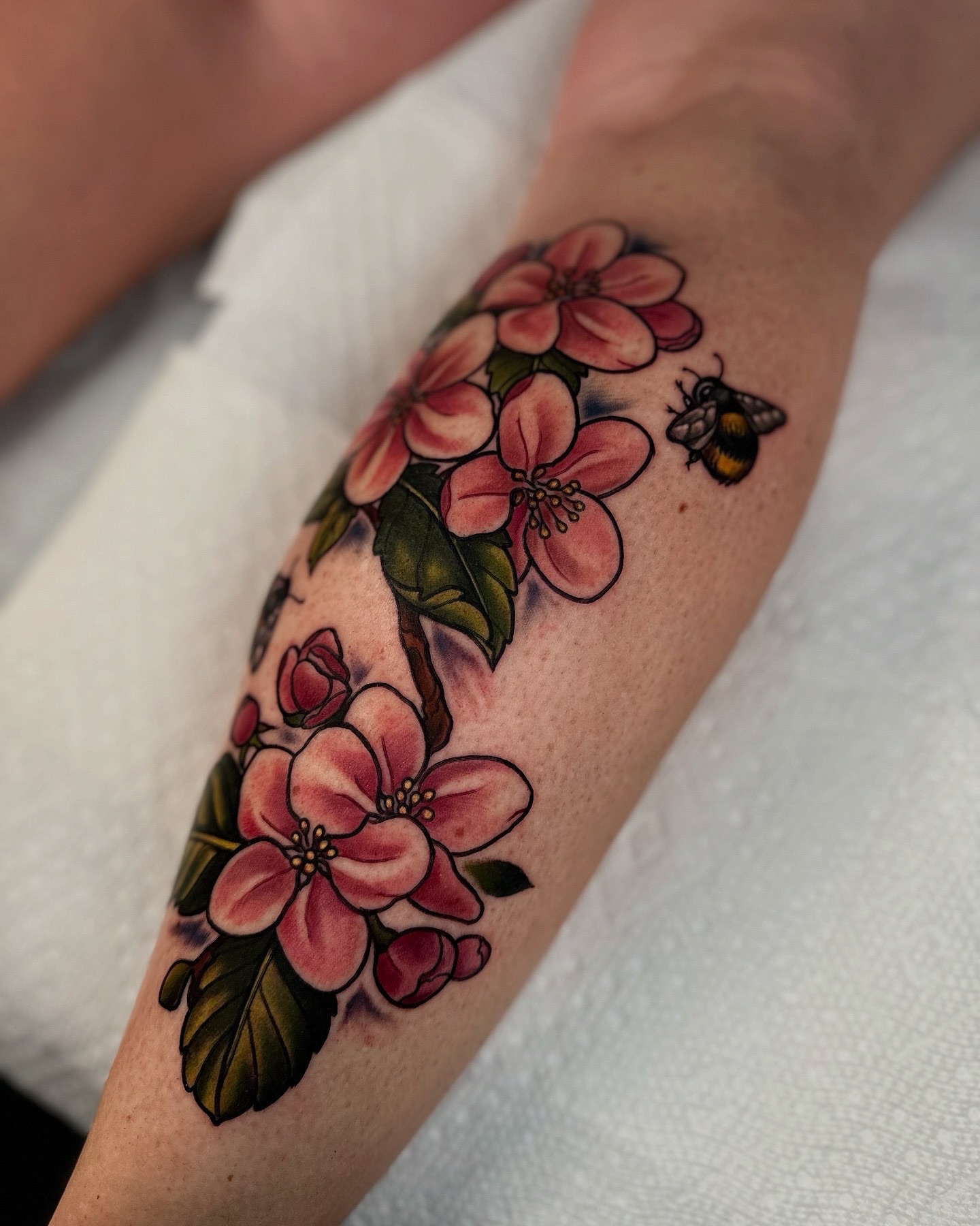 Cherry blossoms and bee realism tattoo on the forearm by ✨Sarah Knapp✨, Eugene, Oregon