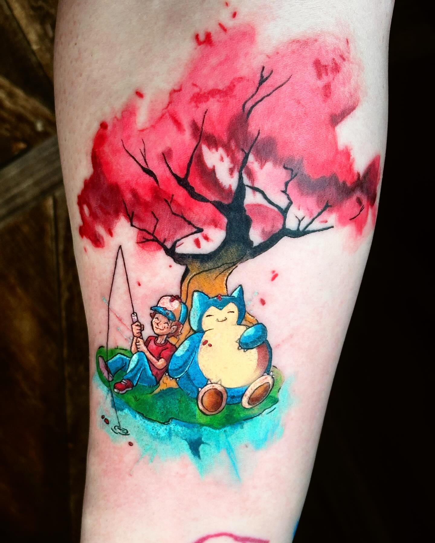 Fishing scene watercolor tattoo on the forearm by Lex