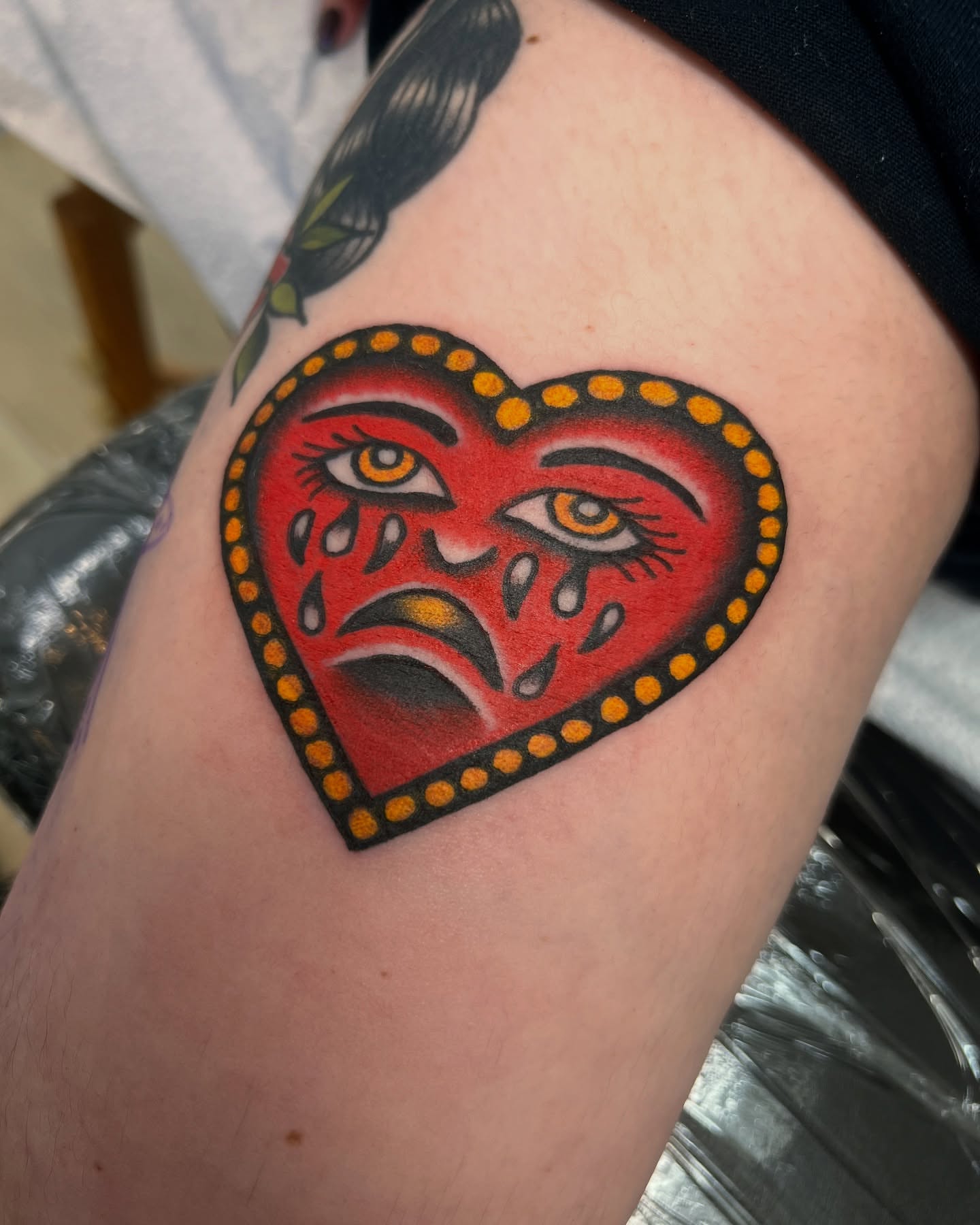 Sad heart American traditional tattoo on the thigh by Shannon Pagliarini