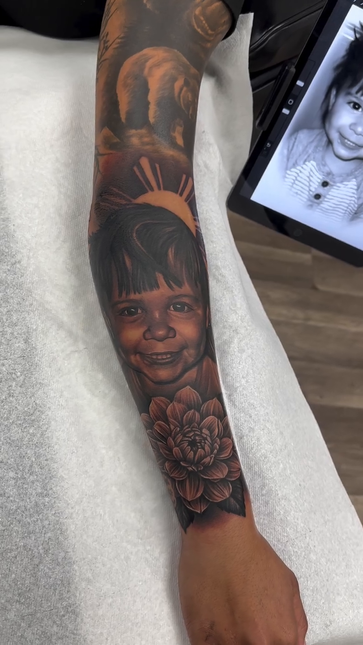 Child portrait and flower realism tattoo by Joshua ramirez, Montebello, California