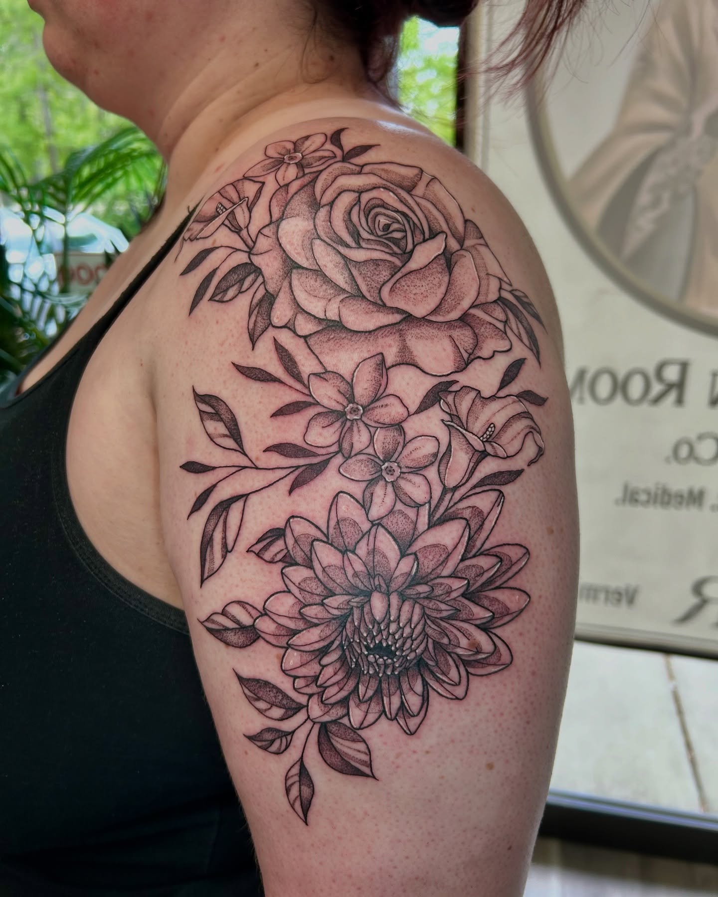 Floral bouquet realism tattoo on the shoulder by Taylor Heidtbrink