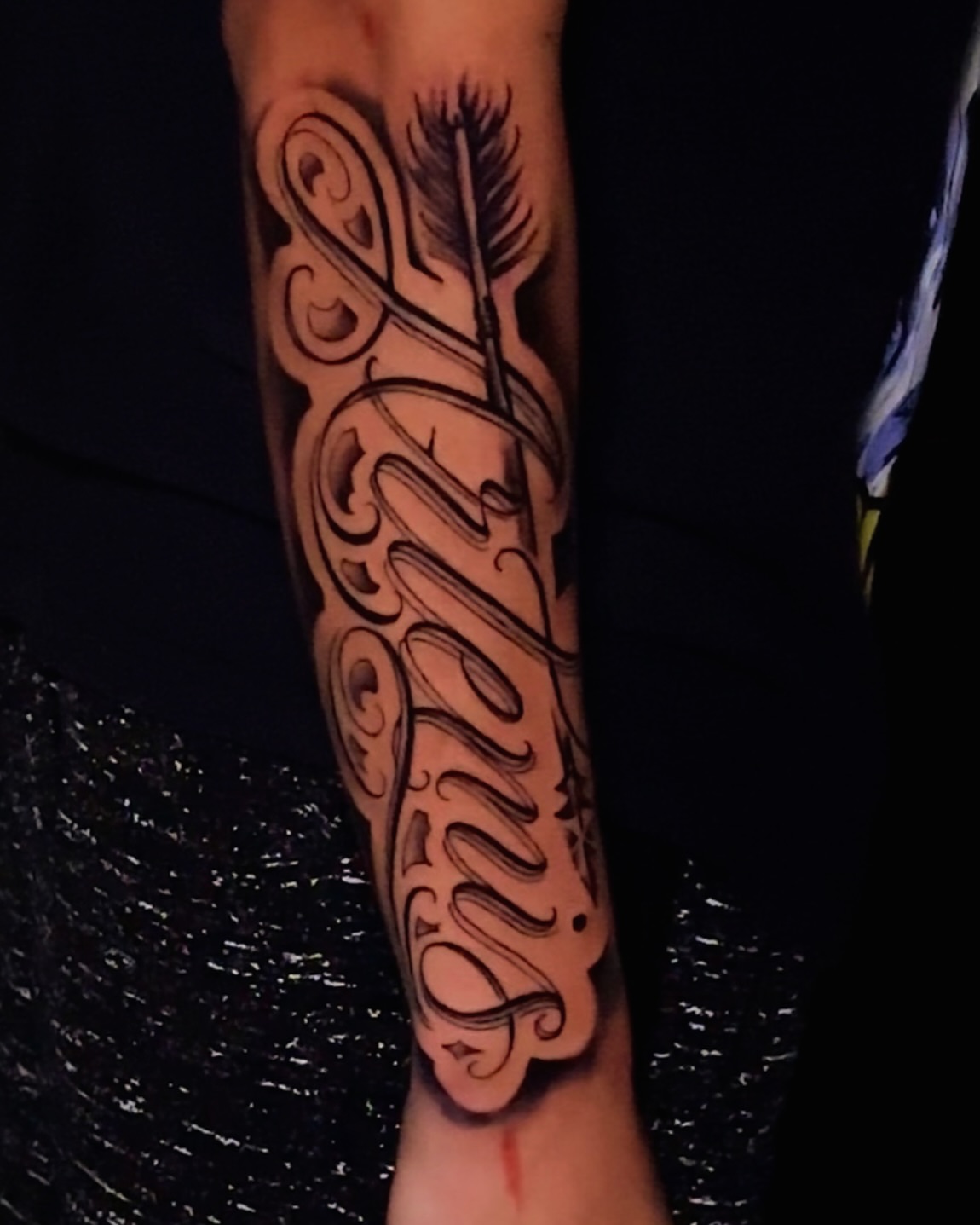 Arrow through cursive text lettering script tattoo on the forearm by Erick @ AZTEC_TATT