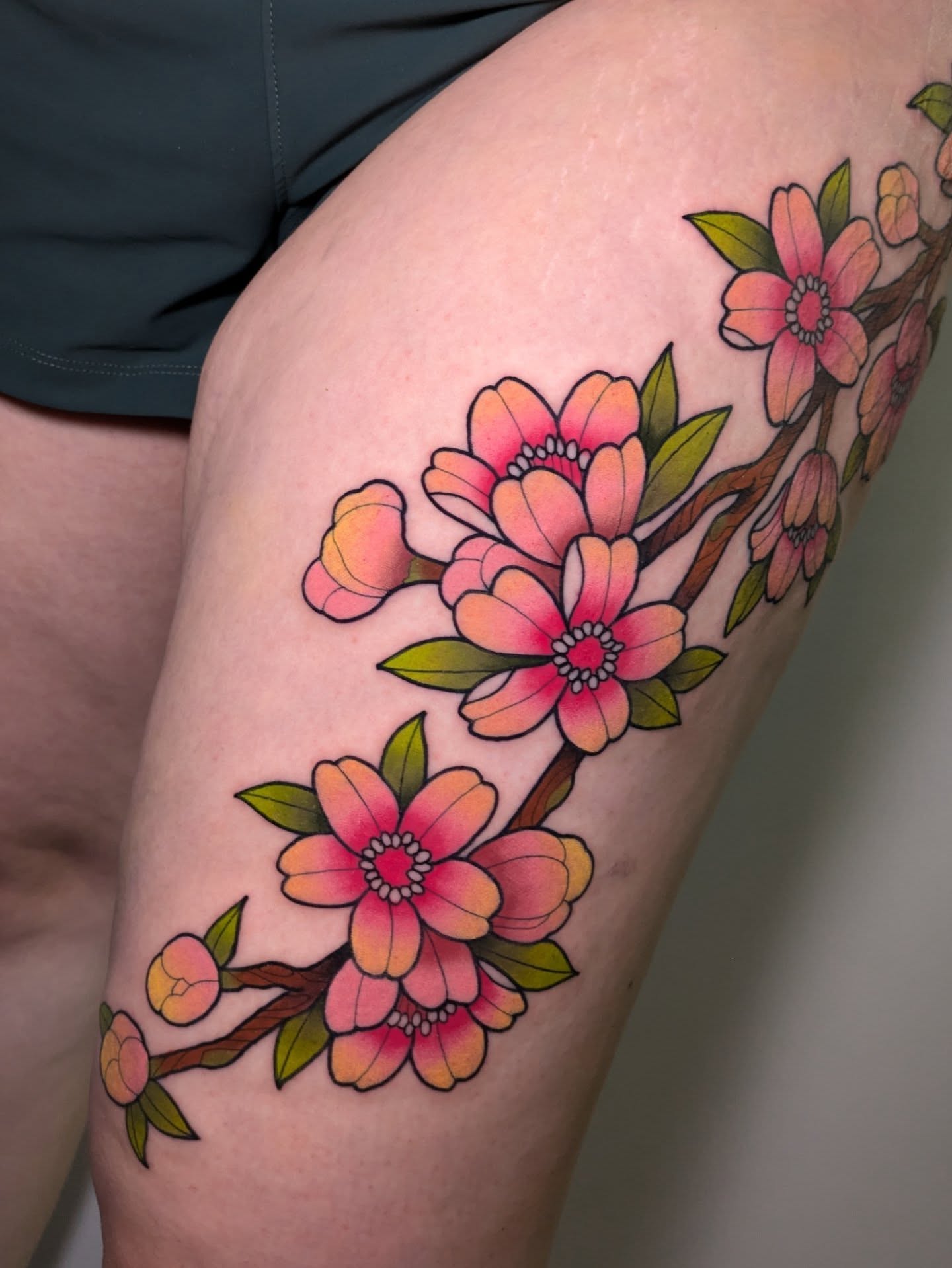 Cherry blossoms new school tattoo on the thigh by Ellie