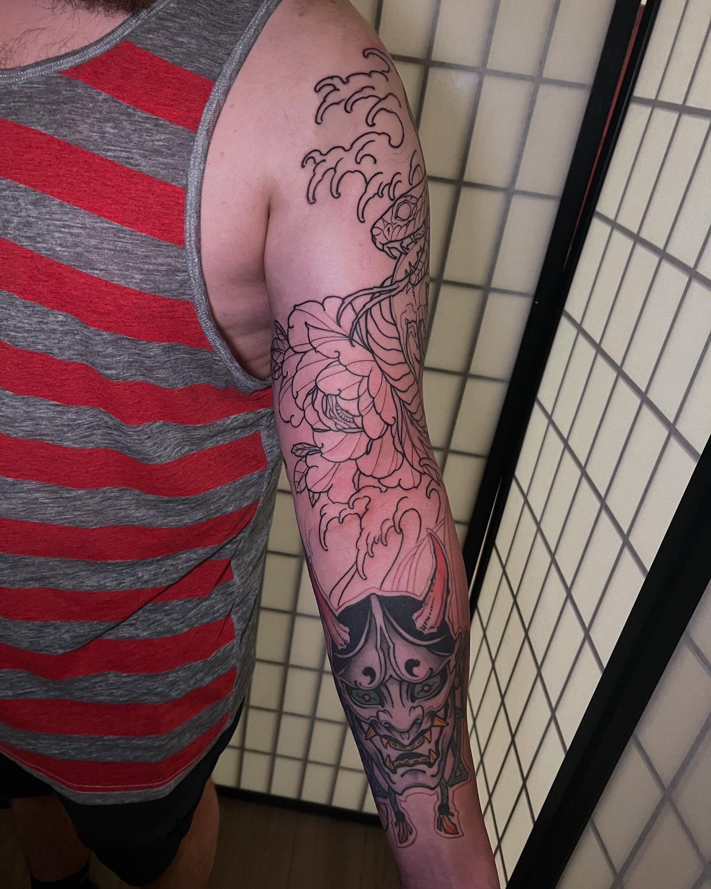 Demon mask and floral japanese irezumi tattoo on the forearm by Neo-Traditional tattoos in Las Vegas