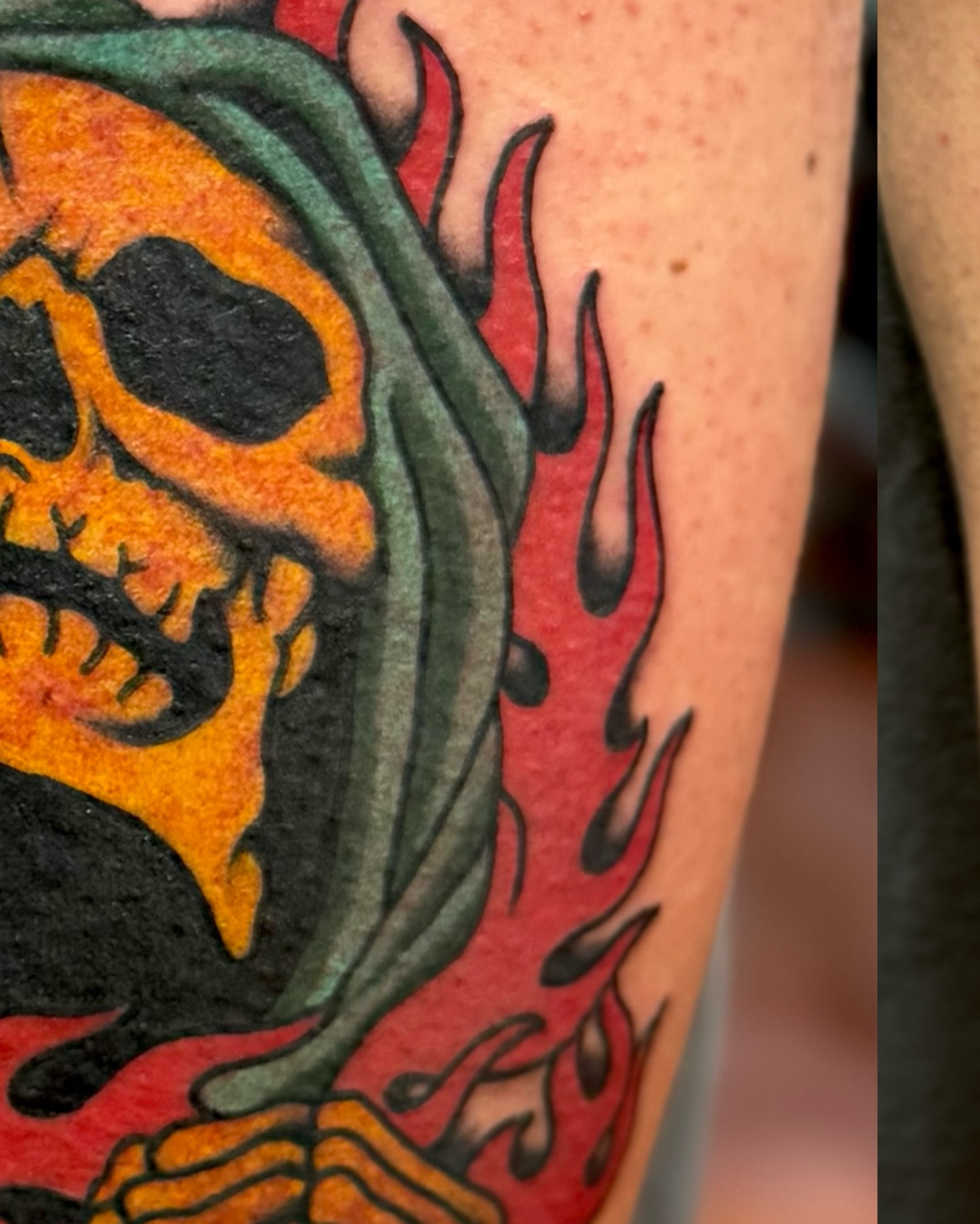 Flaming skull American traditional tattoo on the forearm by Ernie Rivera