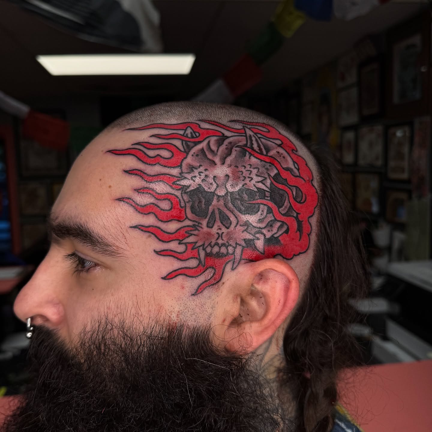 Flaming skull neo-traditional tattoo on the head by Leif Hansen