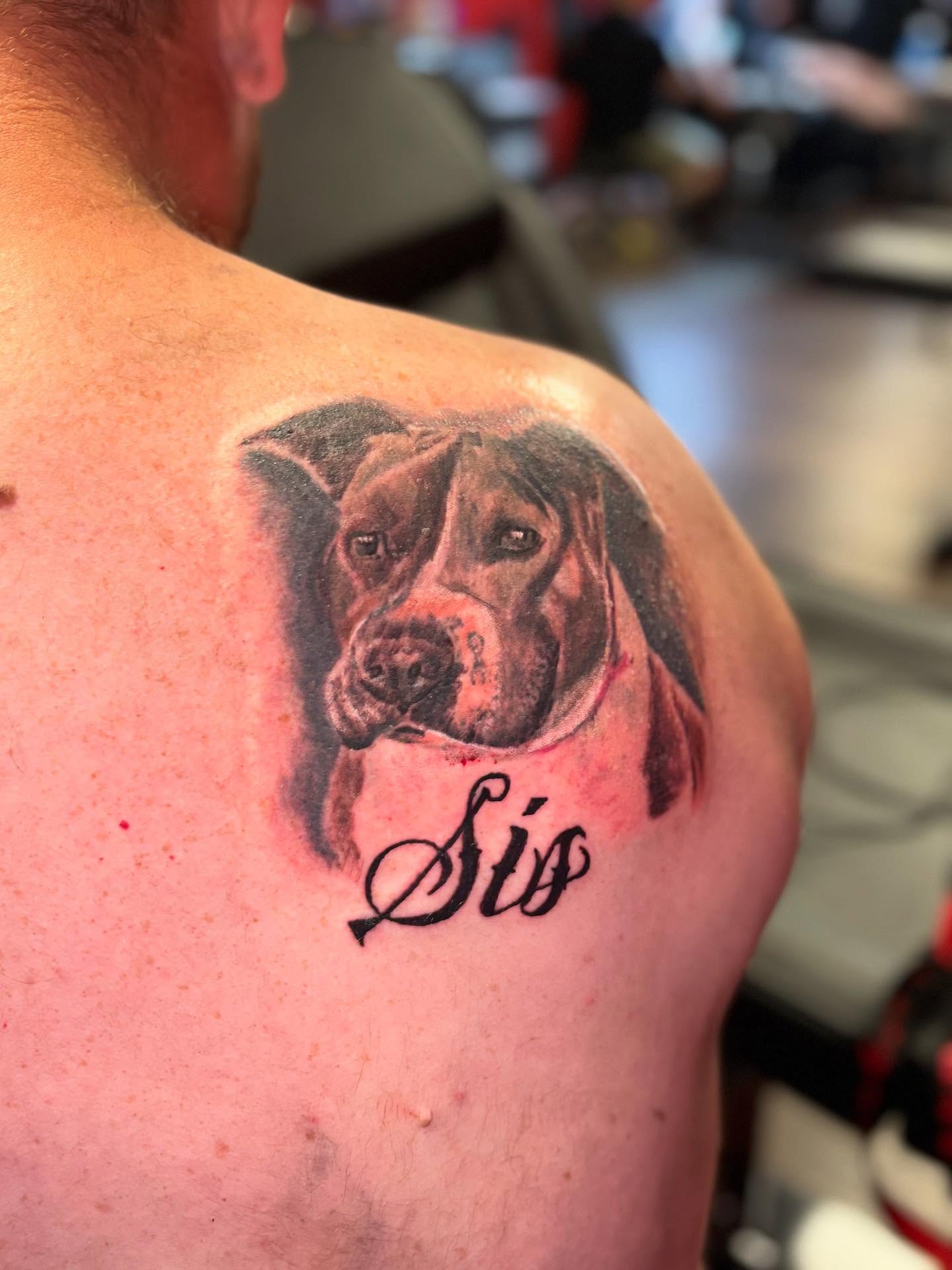 Dog portrait realism tattoo on the shoulder by Dre Ortiz