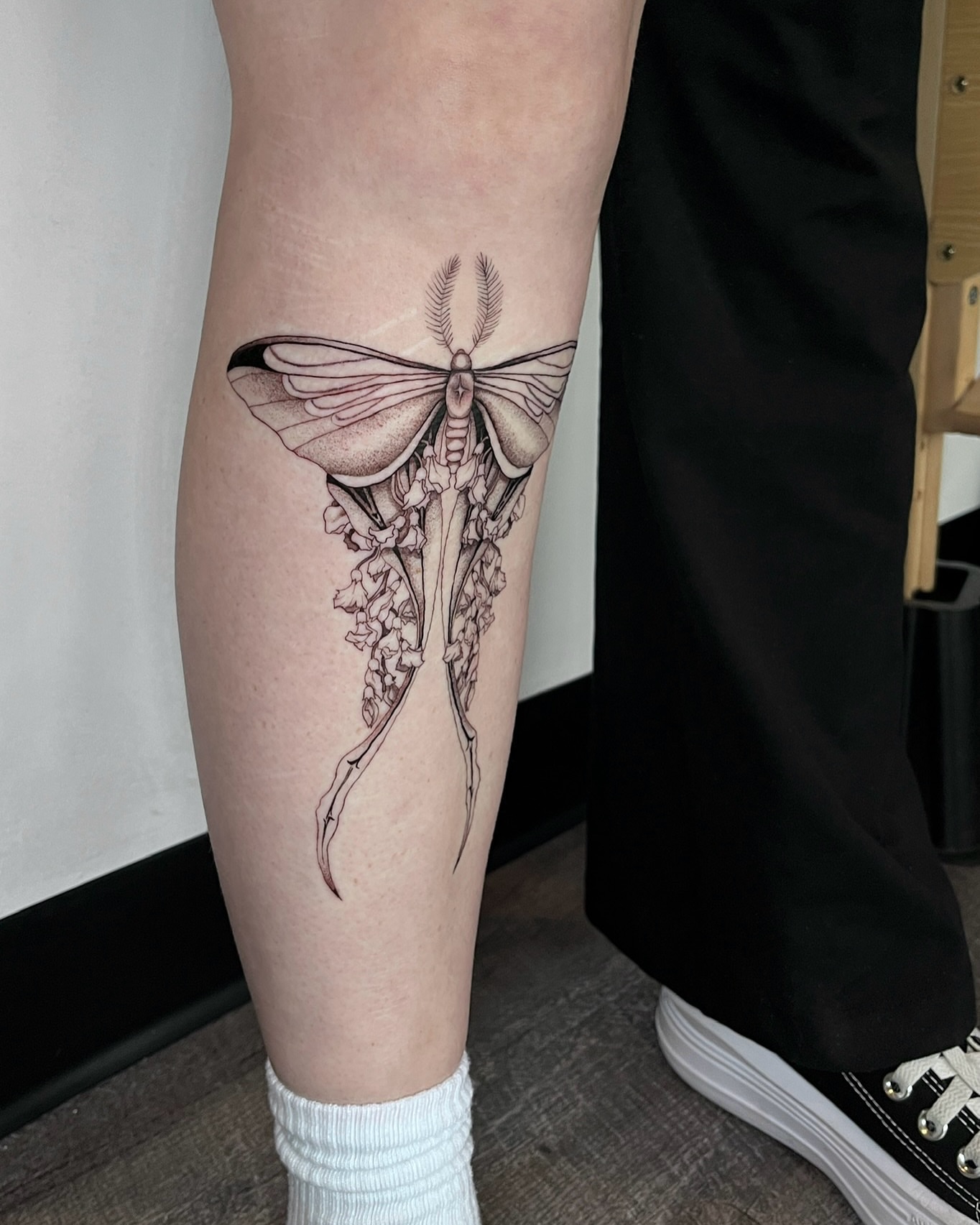 Moth and flowers realism tattoo on the thigh by Samantha