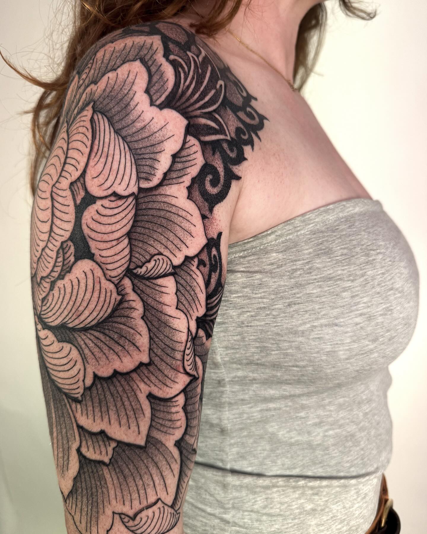 Floral black and grey tattoo on the upper arm by Jamie Beach, Wheat Ridge, Colorado
