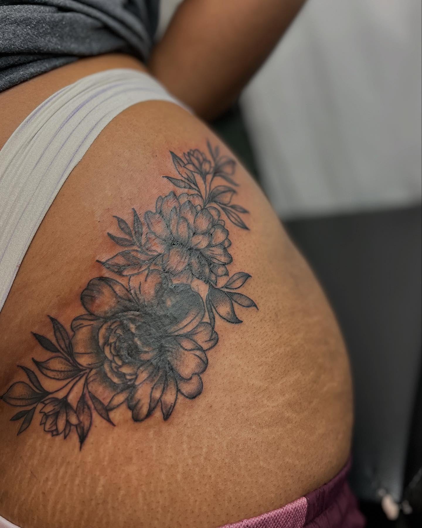 Flowers black and grey tattoo on the thigh by Alesia