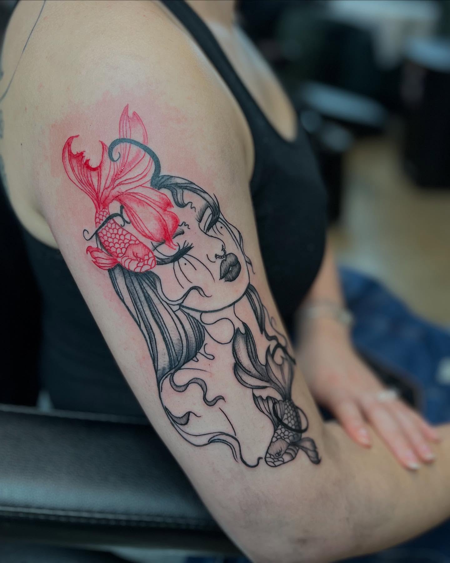 Mermaid and koi fish realism tattoo on the upper arm by Alesia