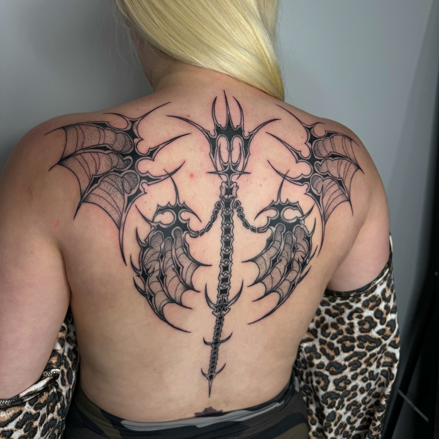 Trident and bat wings geometric tattoo on the back by โโฎโ๐ถ๐๐ฝ๐๐๐ู เฃชโญ las vegas tattoo artist
