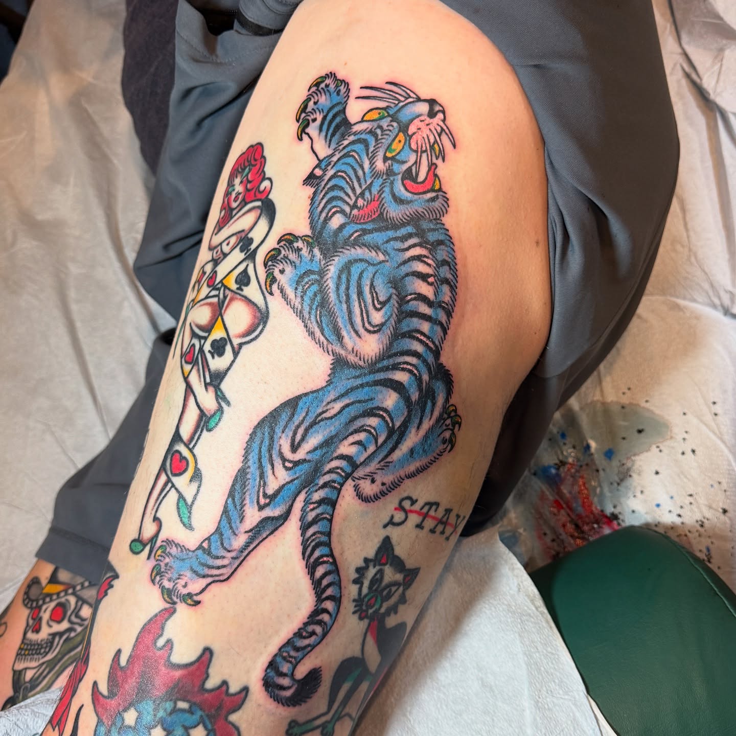 Tiger and woman American traditional tattoo on the thigh by Angus Perfect, Philadelphia, Pennsylvania