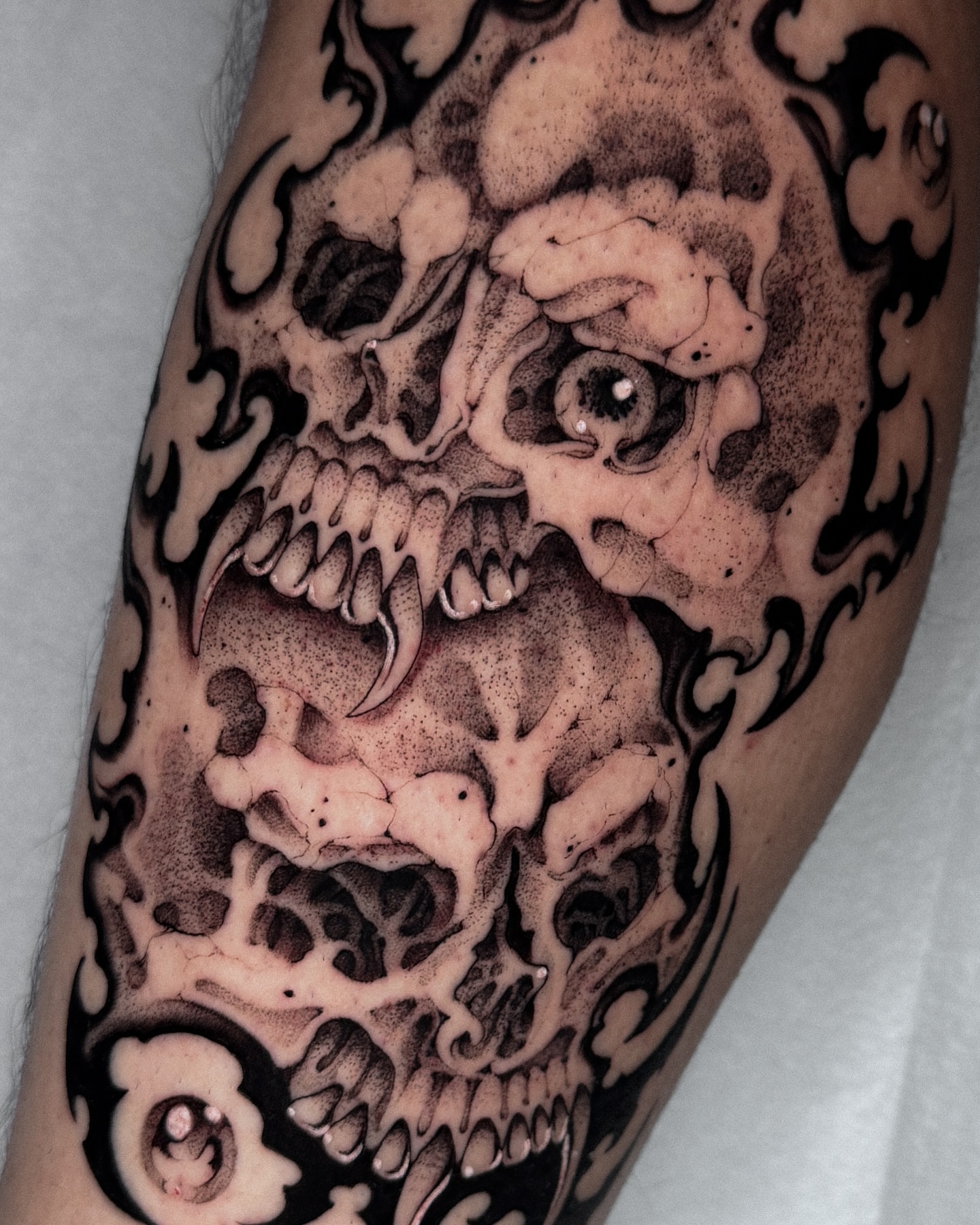 Skull dotwork tattoo on the forearm by ella