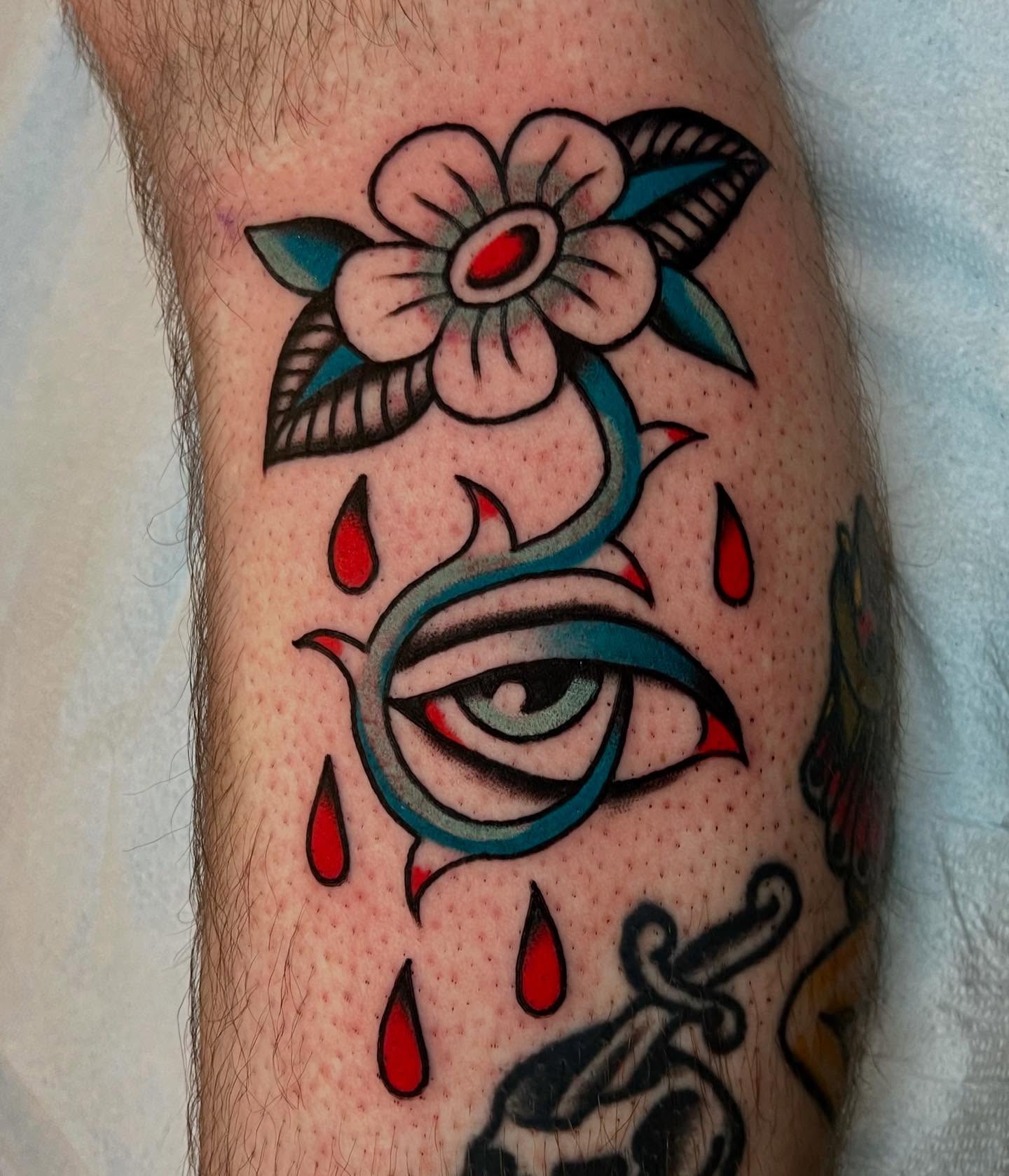 Tearful eye with flower American traditional tattoo on the forearm by Liv :)