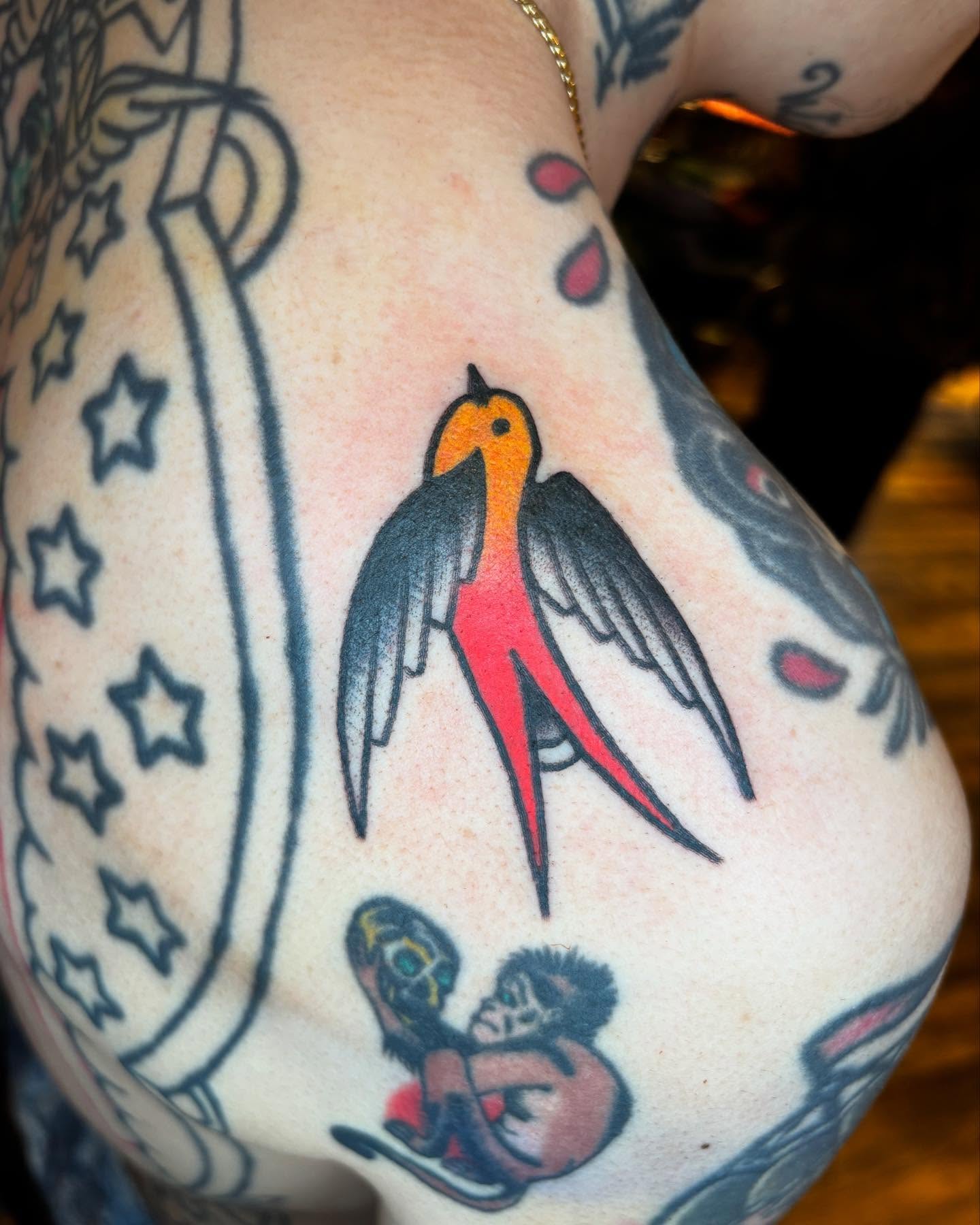 Swallow American traditional tattoo on the upper arm by Rob Keiuf