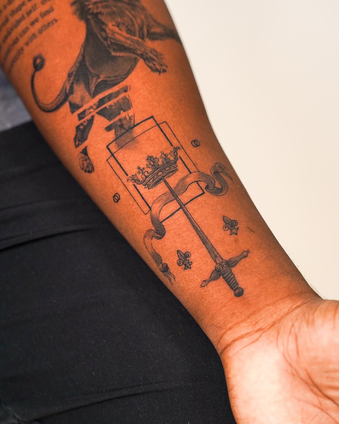 Sword and crown black and grey tattoo on the forearm by Jinzhi ye