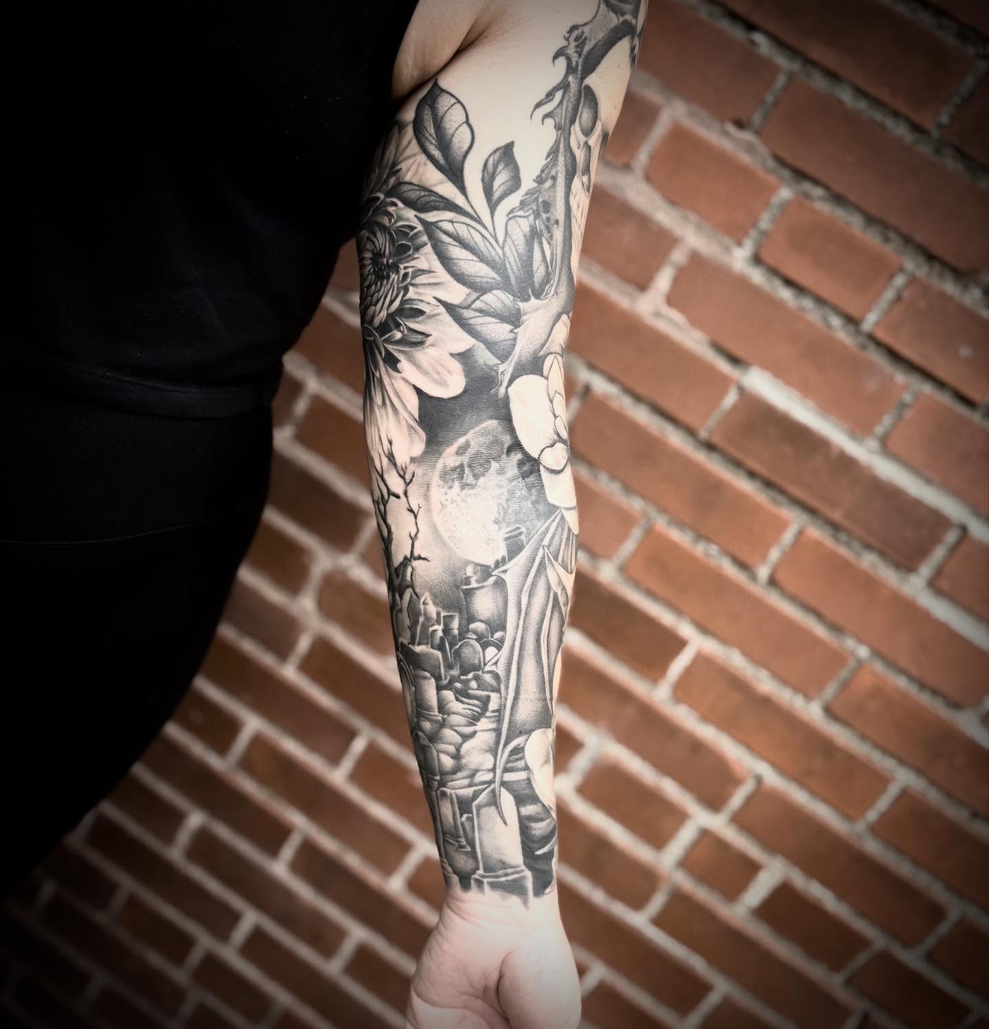 Floral and moon realism tattoo on the forearm by Blake Van Vleck