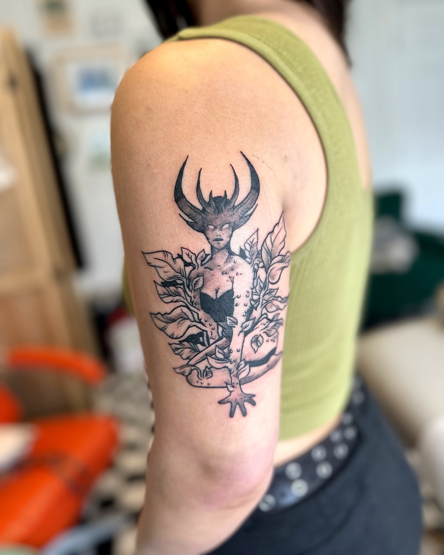 Mythical creature illustrative tattoo on the upper arm by Emma Berger