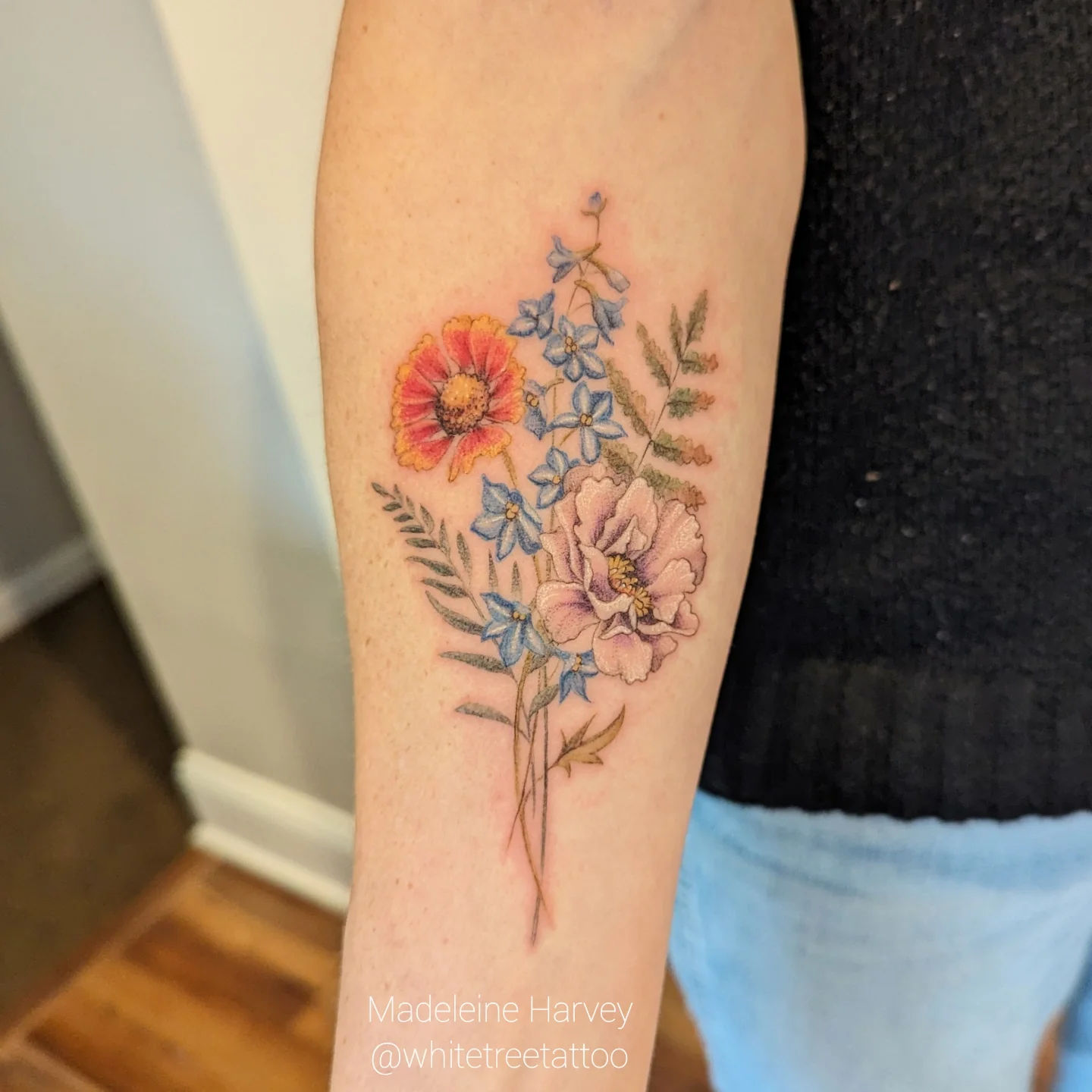 Floral bouquet watercolor tattoo on the forearm by Maddie