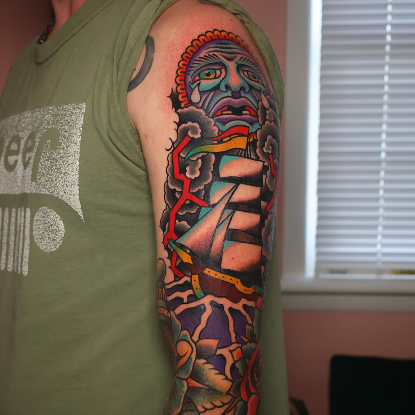 Ship and ghost American traditional tattoo on the upper arm by Big Al