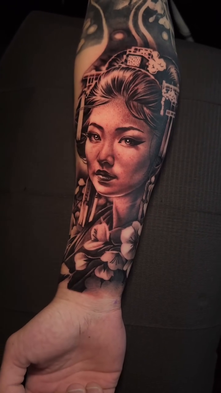 Geisha portrait with flowers realism tattoo by 𝐉𝐨𝐧 𝐒𝐚𝐧𝐭𝐨𝐬