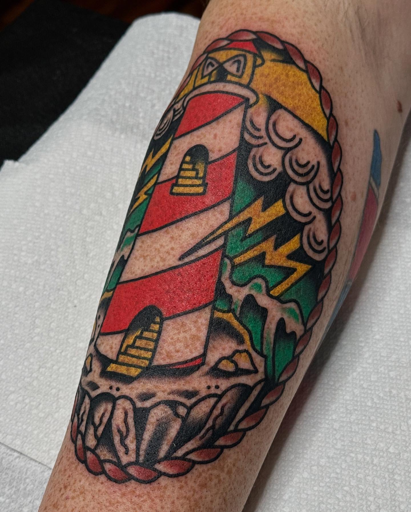 Lighthouse American traditional tattoo on the forearm by Steve Pearson