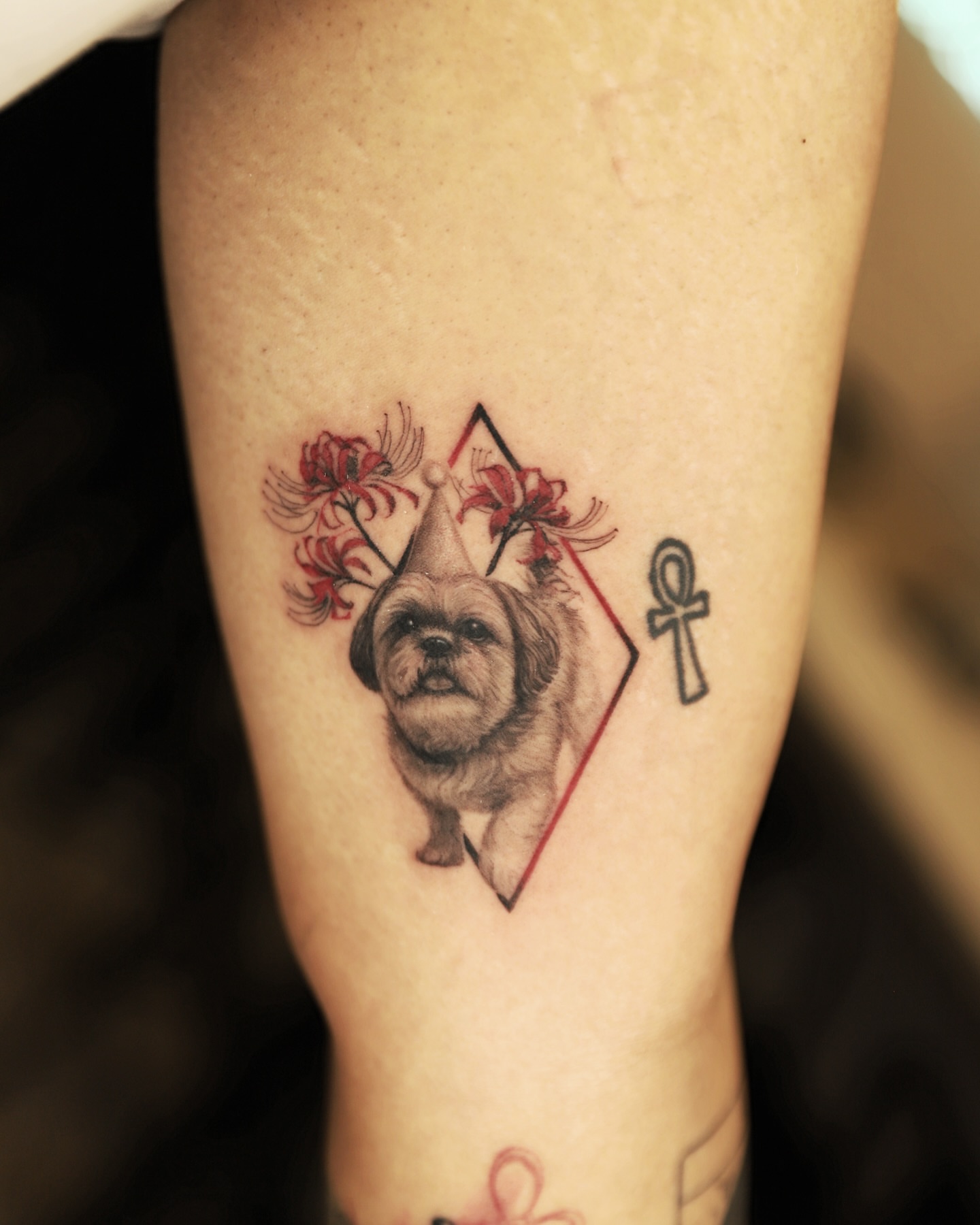 Dog with flowers realism tattoo on the forearm by Las Vegas tattoo