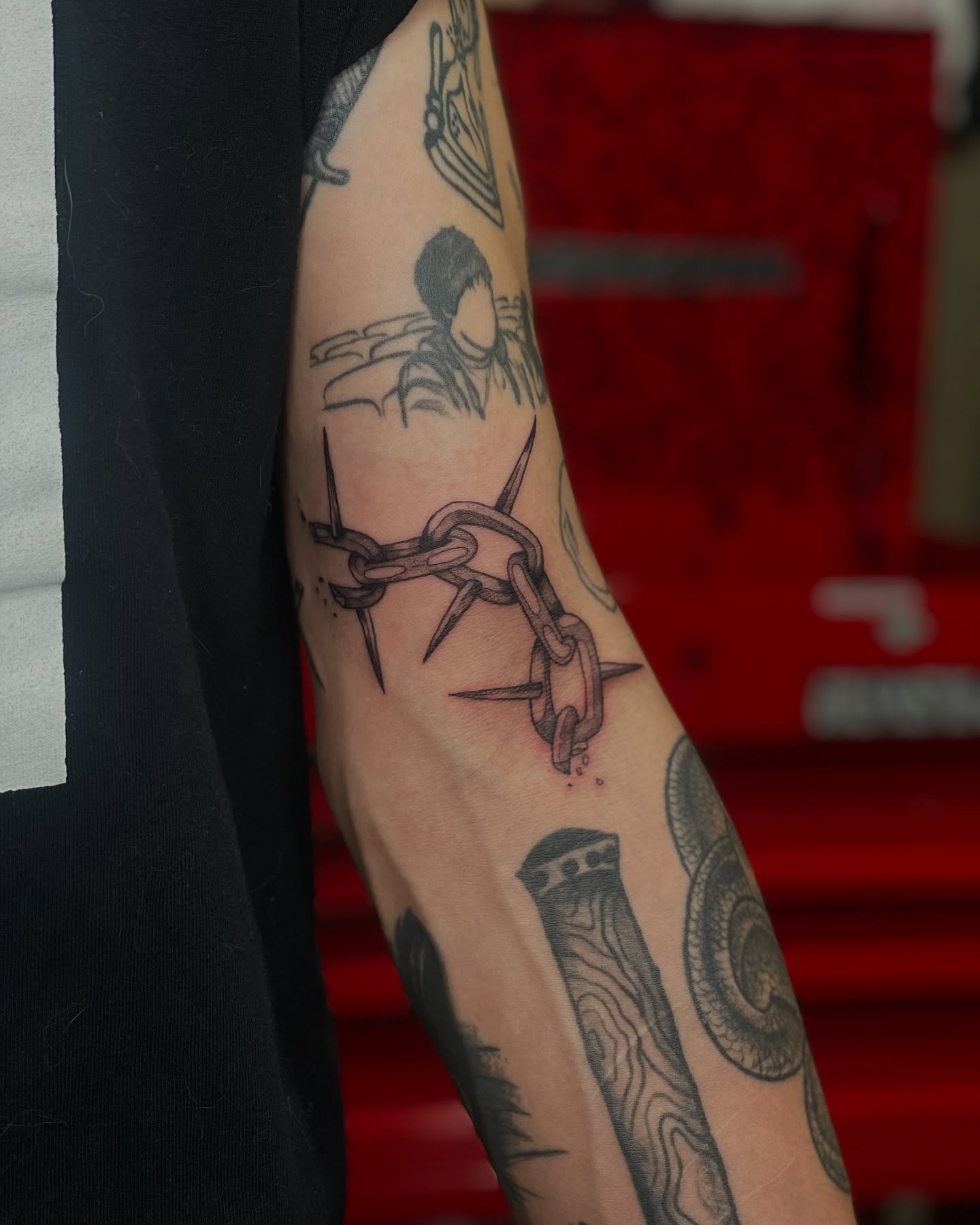 Chains and spikes black and grey tattoo on the forearm by ⊹ * . 𝕵az ⊹ * .