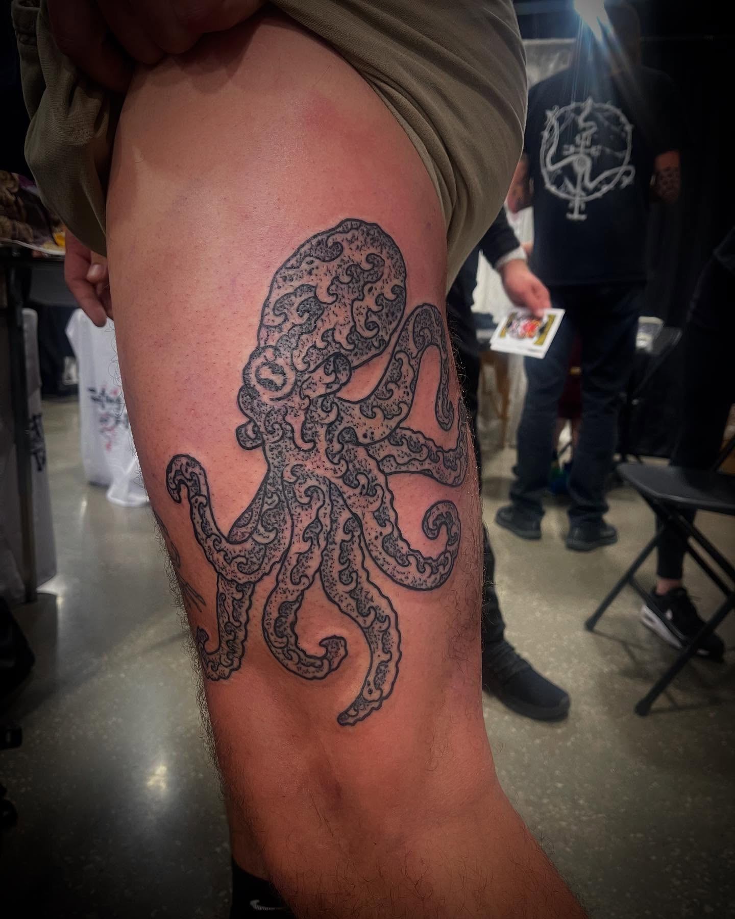 Octopus black and grey tattoo on the thigh by Don Juan