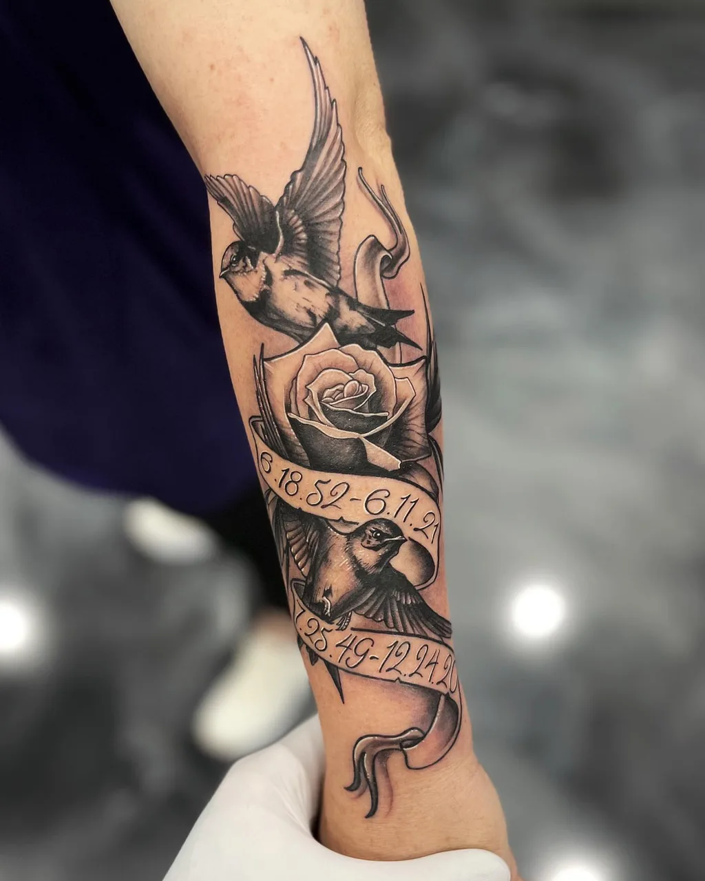 Swallow and rose black and grey tattoo on the forearm by Adam Silfies