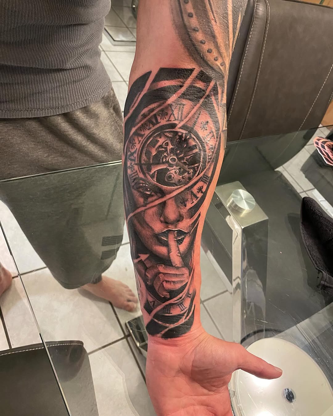 Woman with clockwork surrealism tattoo on the forearm by Tattoos By Mauze