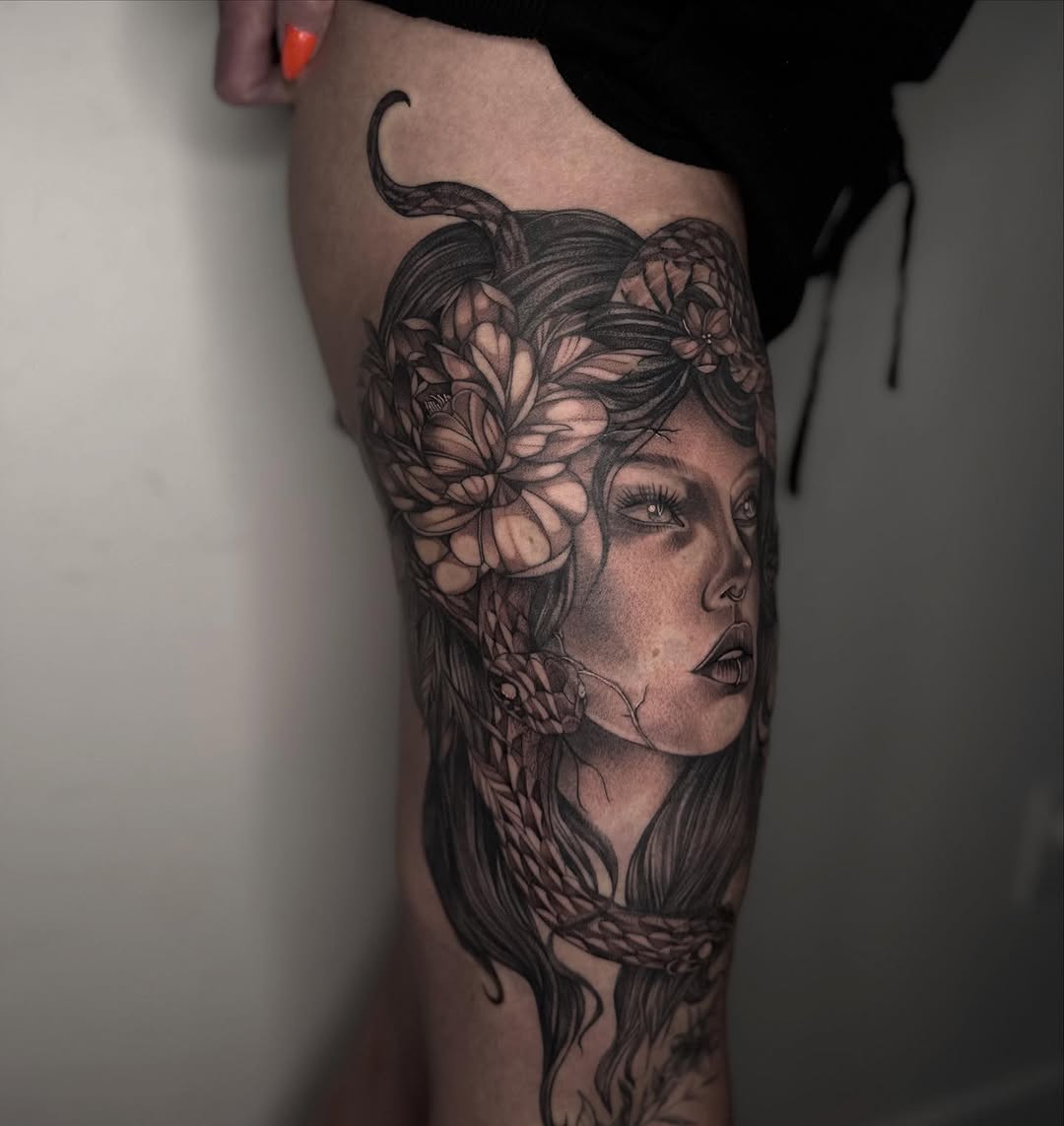 Woman with snake and flowers realism tattoo on the thigh by Isabelle Kellar, San Diego, California